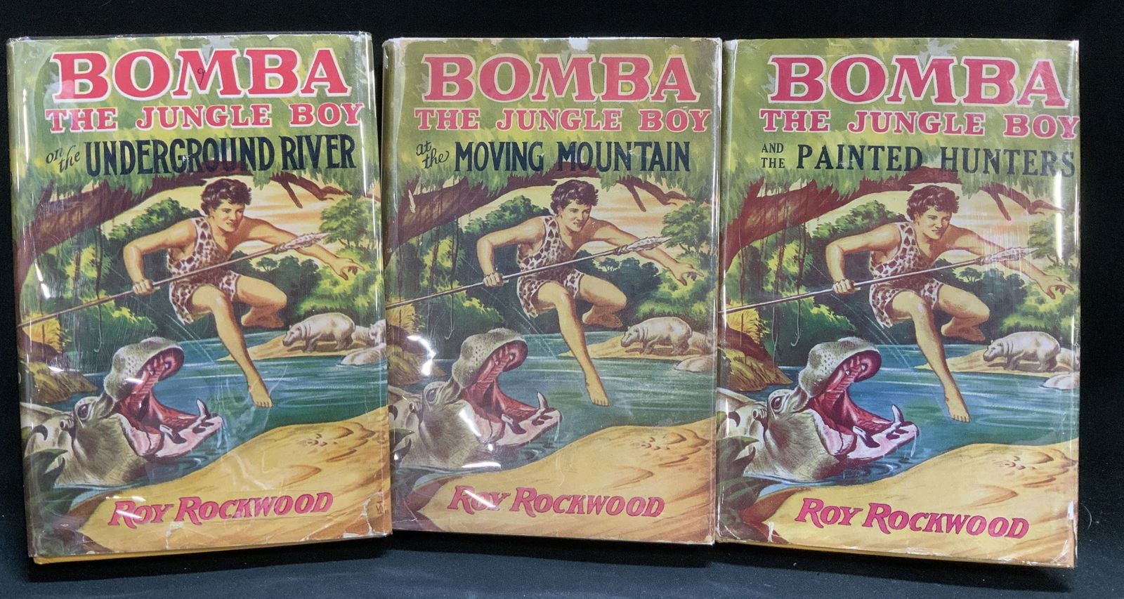 Lot 3 Bomba The Jungle Boy 1920-1930s Bks ROCKWOOD: Lot includes, Bomba The Jungle Boy on the Underground River (1930), Bomba The Jungle Boy at the Moving Mountain (1926) & Bomba The Jungle Boy & the Painted Hunters (1932). Books by Roy Rockwood. Books