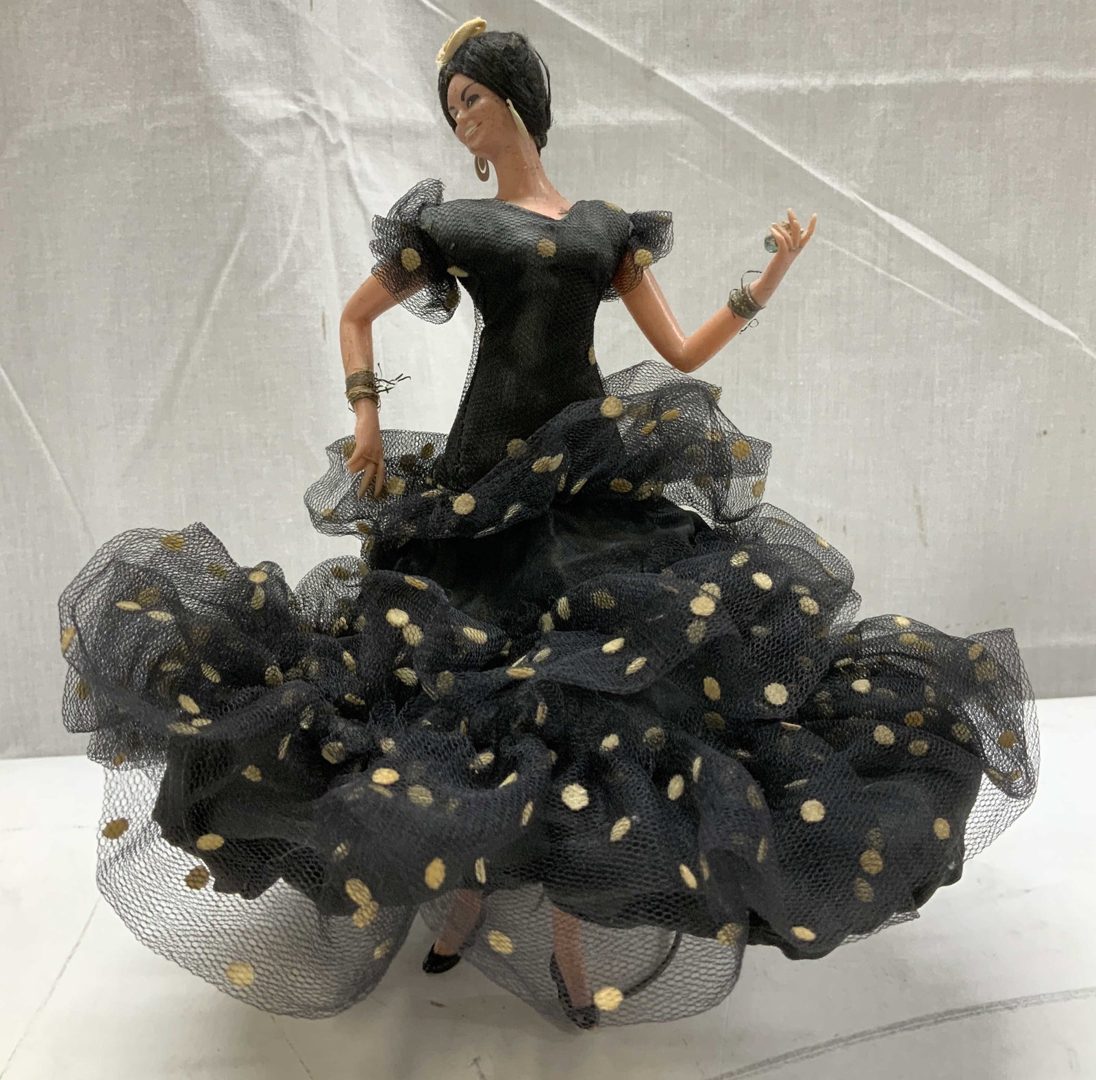 Vntg Spanish Flamenco Dancer Doll: Vintage Spanish flamenco dancer doll is dressed in a traditional black flamenco dress with multiple ruffles & gold polka dots. Surface wear consistent to age, use & exposure. Property of opera singers
