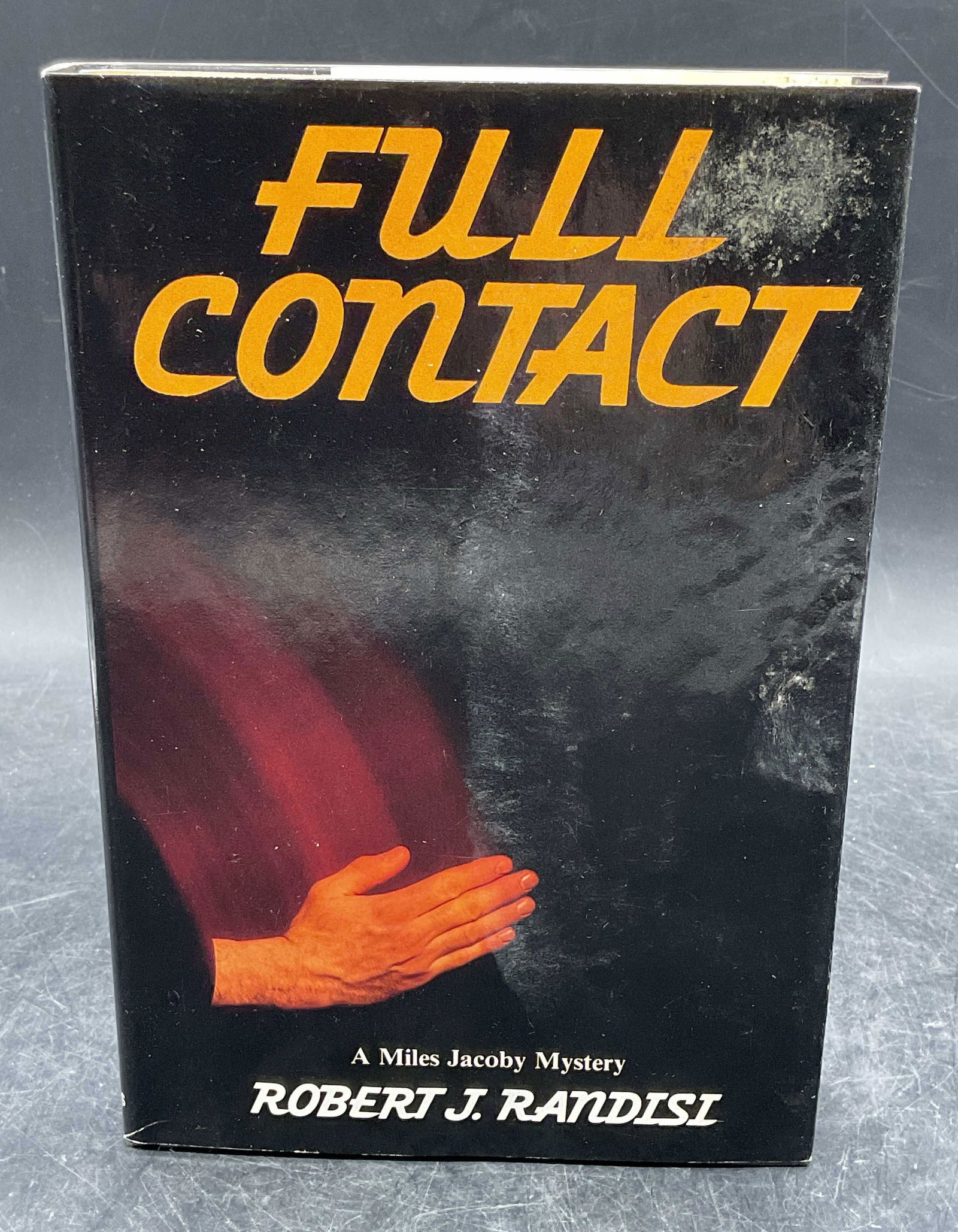 1984 Robert Randisi Full Contact 1st Edition: Hardcover first edition copy of Full Contact by Robert J Randisi. St Martins Press, 1984. Measures approx. 8.5 x 5.75 inches. Evident water damage. Some wear to cover, pages, and binding consistent wi