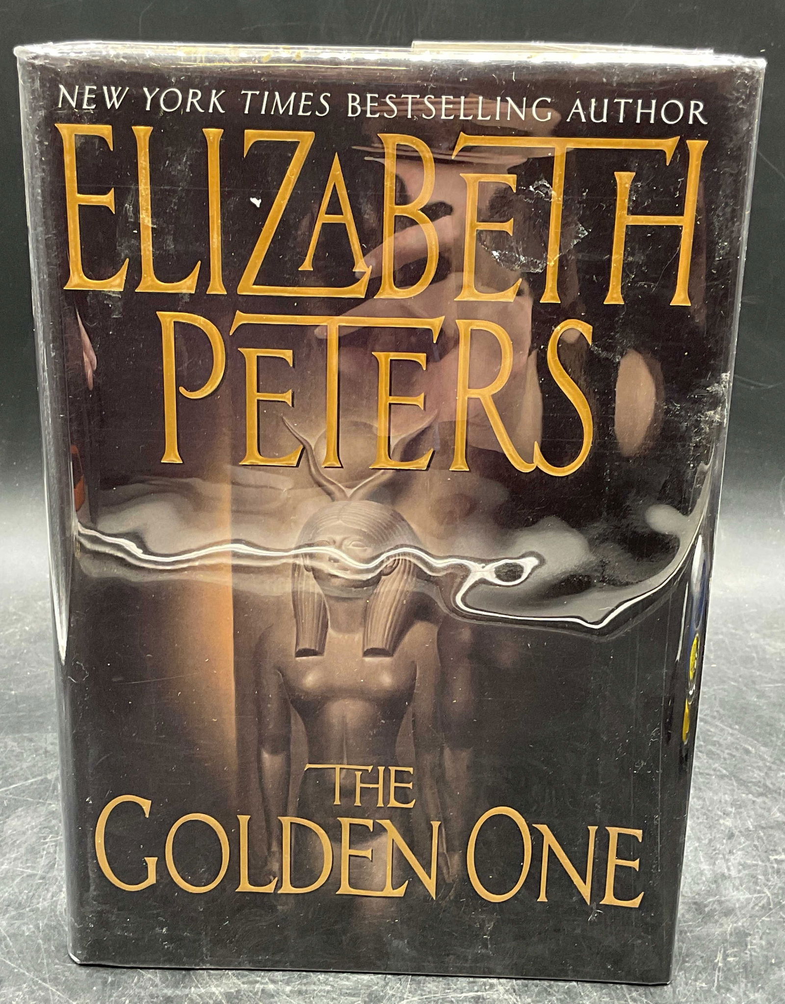 2002 Elizabeth Peters Golden One 1st Edition: Hardcover first edition copy of The Golden One by Elizabeth Peters. Morrow, 2002. Measures approx. 9.25 x 6.5 inches. Some wear to cover, pages, and binding consistent with exposure. Book, first editi