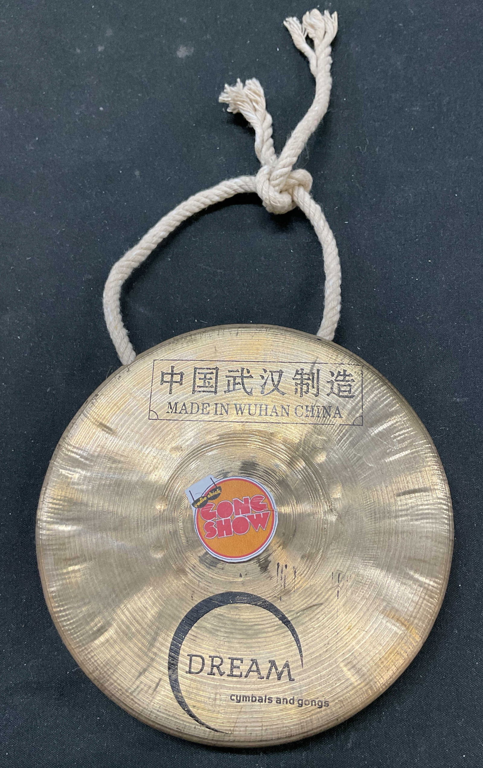 Vintage Dream Chinese Bronze Gong: Vintage Dream Chinese bronze gong. Signed with Chinese characters. Reads Dream cymbals and gongs, Gong Show. Circular shape with ribbed pattern. Rope attached. Measures approx 5 inches in diameter. Su