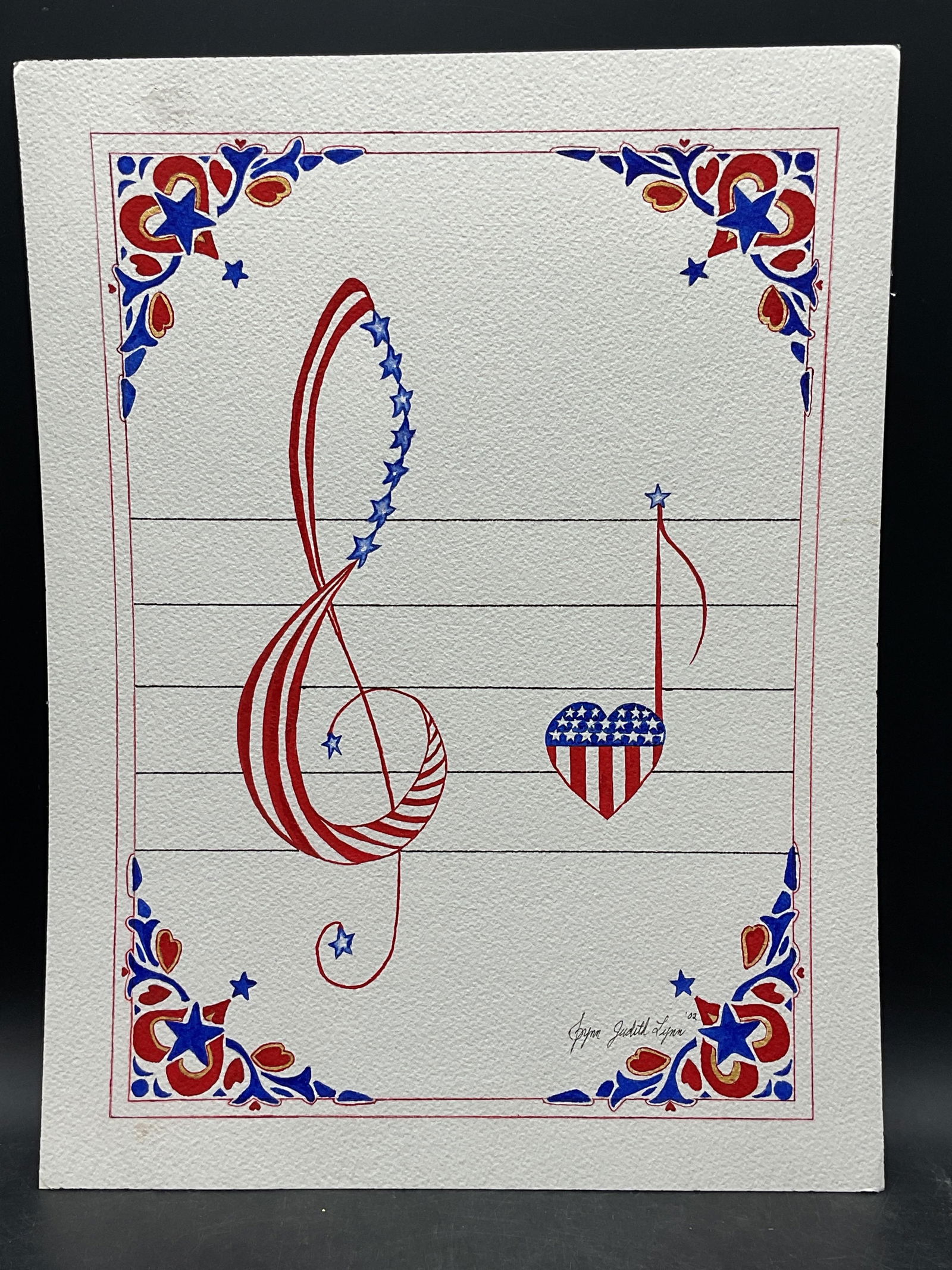 Judith Lynn Americana Music Notes Watercolor: Watercolor painting on paper. Signed Judith Lynn. Red, white and blue American flag and music notes. Measure approx 12 x 16 inches. Some wear consistent with exposure. Property of opera singers estate