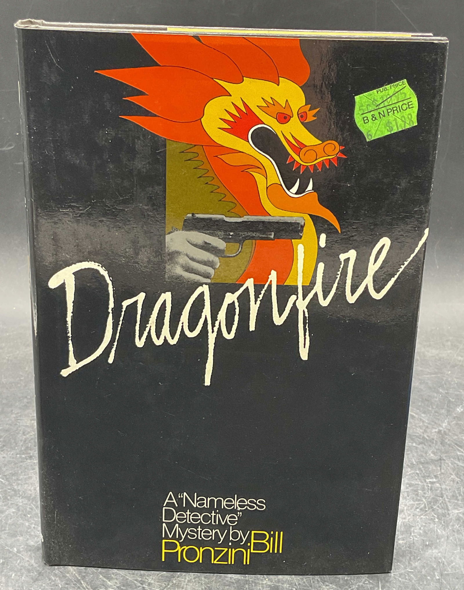 1982 Bill Pronzini Dragonfire 1st Edition: Hardcover first edition copy of Dragonfire by Bill Pronzini. St Martins Press, 1982. Measures approx. 8.5 x 5.75 inches. wear to cover, pages, and binding consistent with exposure. Book,