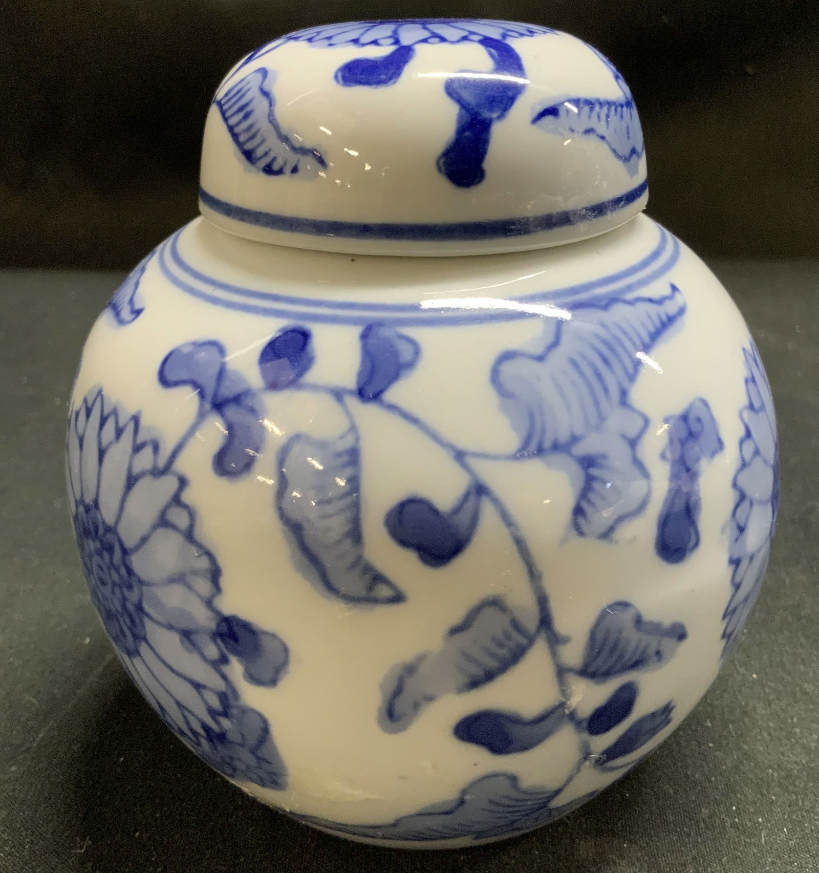 Vtg Blue & White Porc Lidded Vessel: Vintage blue & white porcelain lidded vessel featuring traditional leaf & sunflower motifs on body. Surface wear consistent to age, use & exposure. Measurements: length 3.2in x width 3.2in x