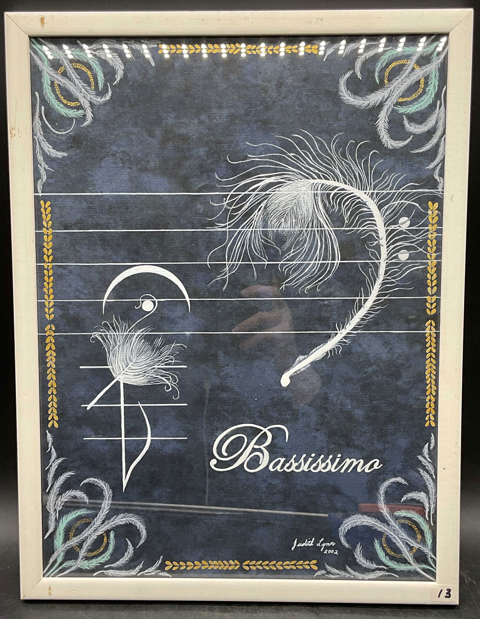 Judith Lynn Bassissimo Feather Watercolor Painting: Framed watercolor and gold leaf painting on paper. Signed Judith Lynn. Bassissmo. Fathers and music notes. White wood frame. Not examined out of frame. Frame measures approx 17 x 13 inches. Some