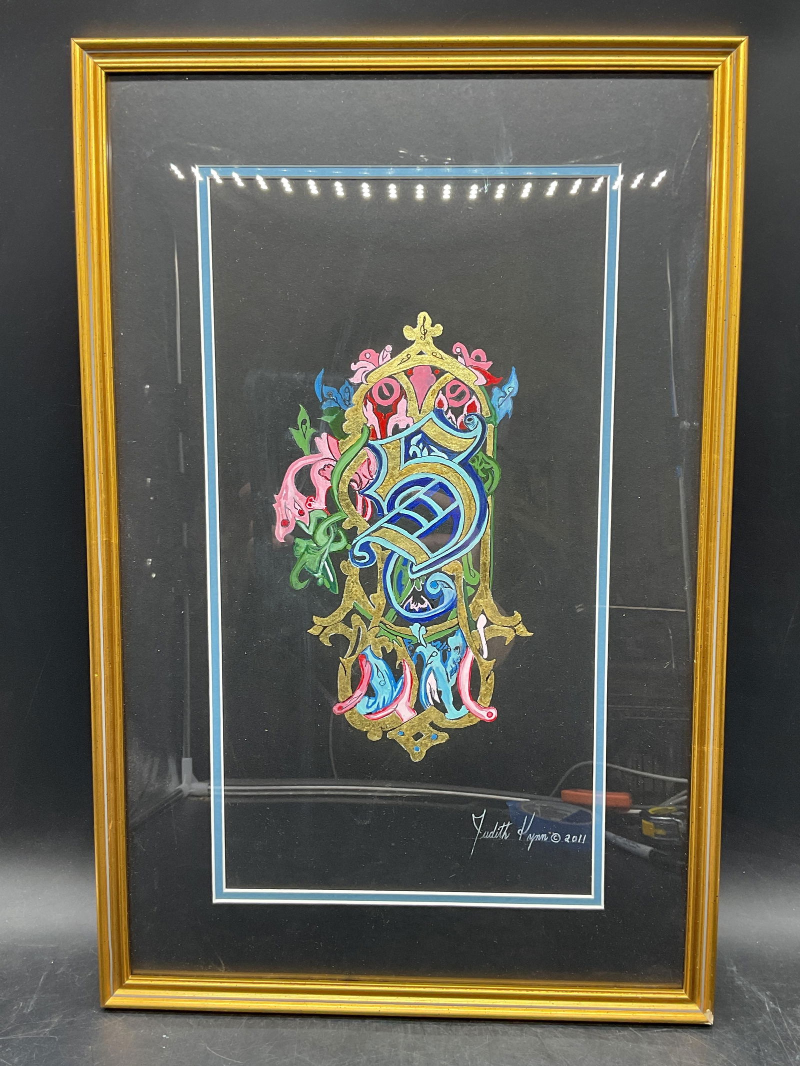 Judith Lynn Gothic Letter S Watercolor Painting: Framed watercolor, ink and 18k gold leaf painting on paper. Signed Judith Lynn. Gothic letter S. Gold tone wood frame. Not examined out of frame. Frame measures approx 19.5 x 12.75 inches. Some