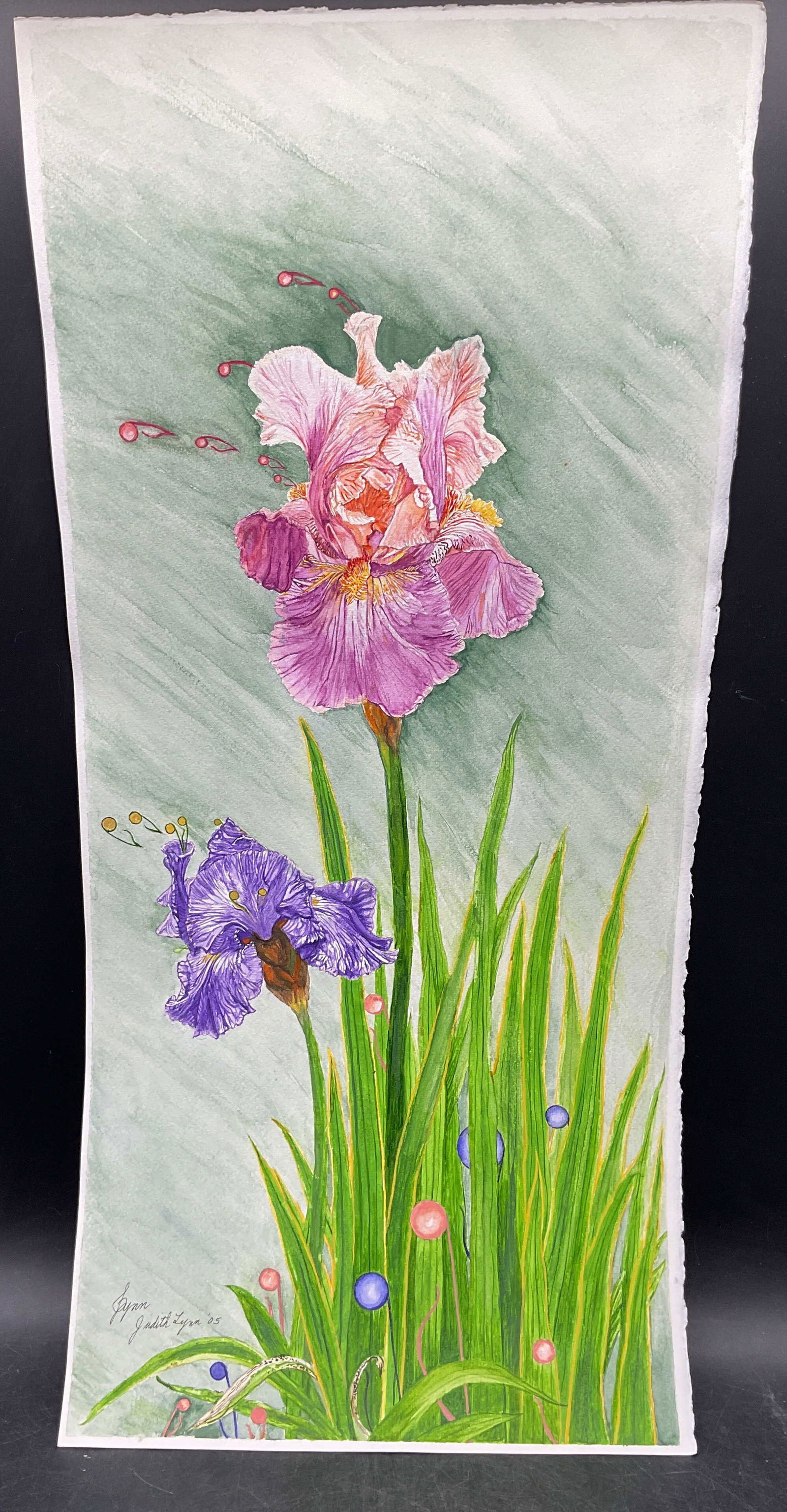 Signed Judith Lynn Flowers Watercolor Painting 2ft: Watercolor painting on paper. Signed Judith Lynn. Pink and purple flowers with music notes. Measures approx. 24 x 11 inches. Some wear consistent with exposure. Property of opera singers estate