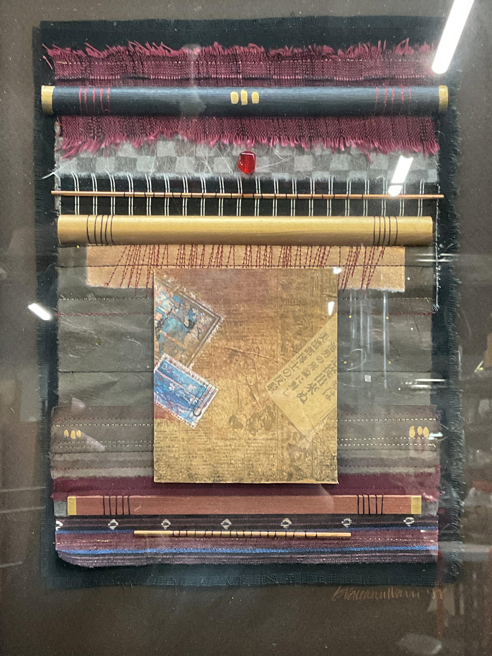 Framed Signed Warn Mixed Media Collage 1988: Framed and mounted mixed media collage. Signed and dated lower right, Graceann Warn, 1988. Textile, wood, pigment. Geometric composition in blue, red, and gold. Black frame. Not examined out of frame.