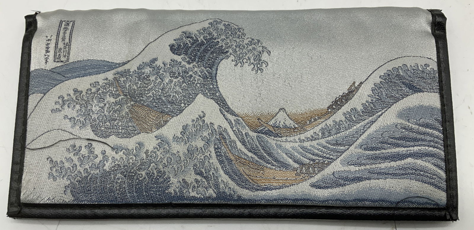 Japanese Great Wave Long Bifold Wallet: Long bifold wallet features a Japanese inspired wave motif & interior has multiple card slots. Zippered compartment. Comes with gold box (no lid). Surface wear consistent to age, use & exposure. Prope