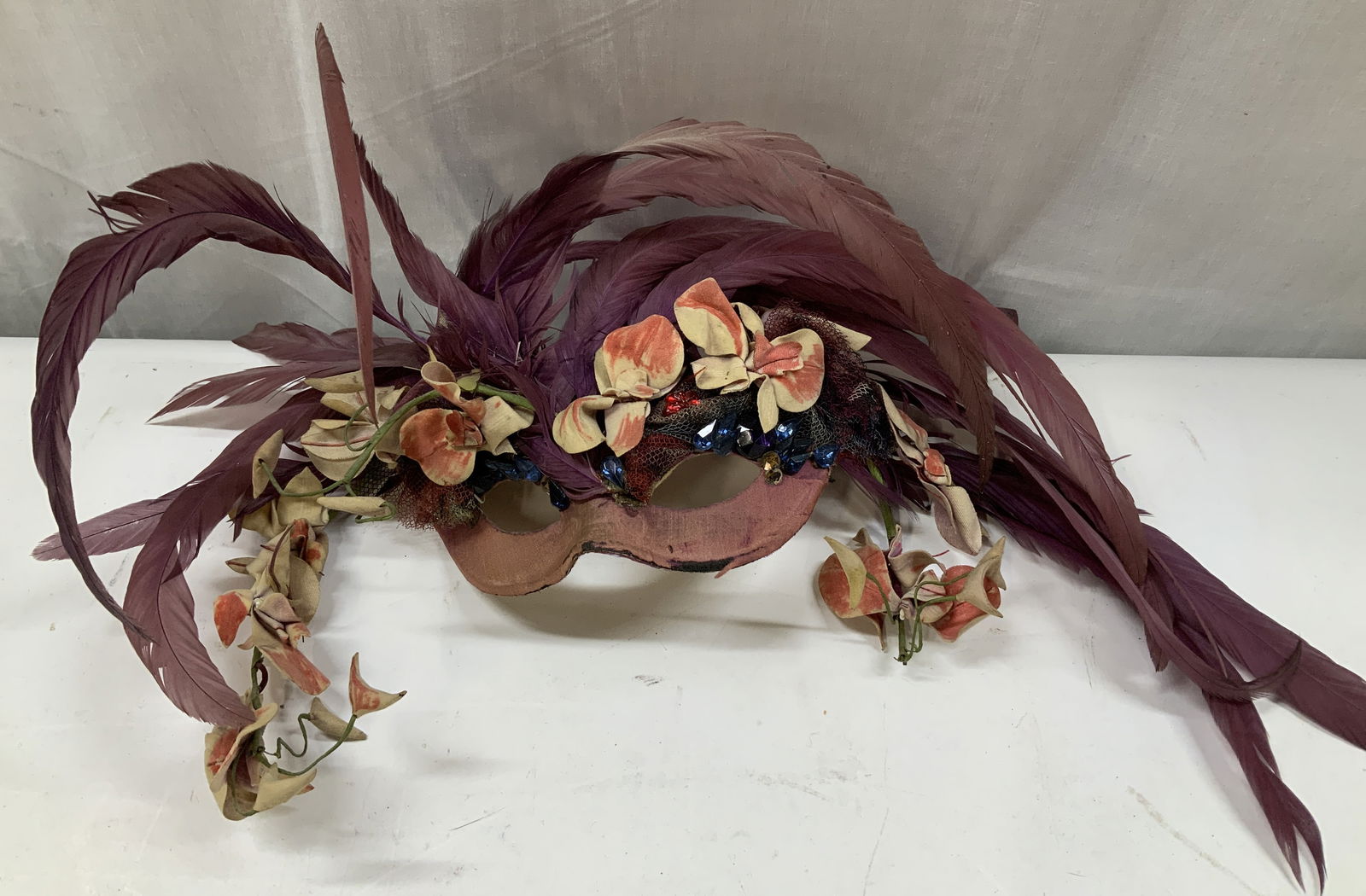 Vtg Feathered & Jeweled Masquerade Mask: Vintage masquerade mask features purple feather accents & jeweled embellishments. Floral detailing. Fabric material. Property of opera singers estate from the renowned & opulent Manhattan