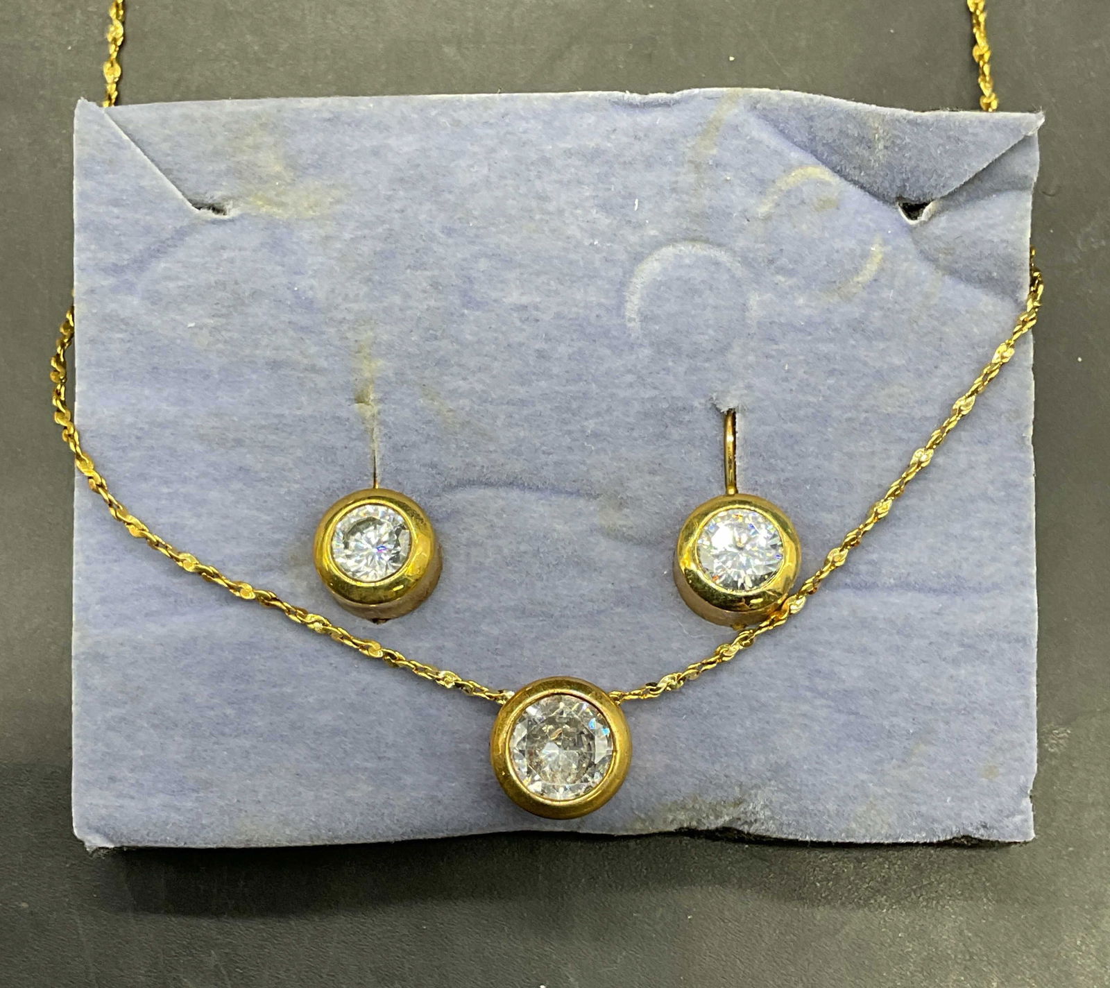 Lot 2 Avon Gold Tone CZ Necklace & Earrings: Lot of 2 matching signed Avon gold tone cubic zirconia pendant necklace and earrings. Necklace drop length approx 8.5 inches. Includes original box. Some scratching. Jewelry, estate jewelry, costume j
