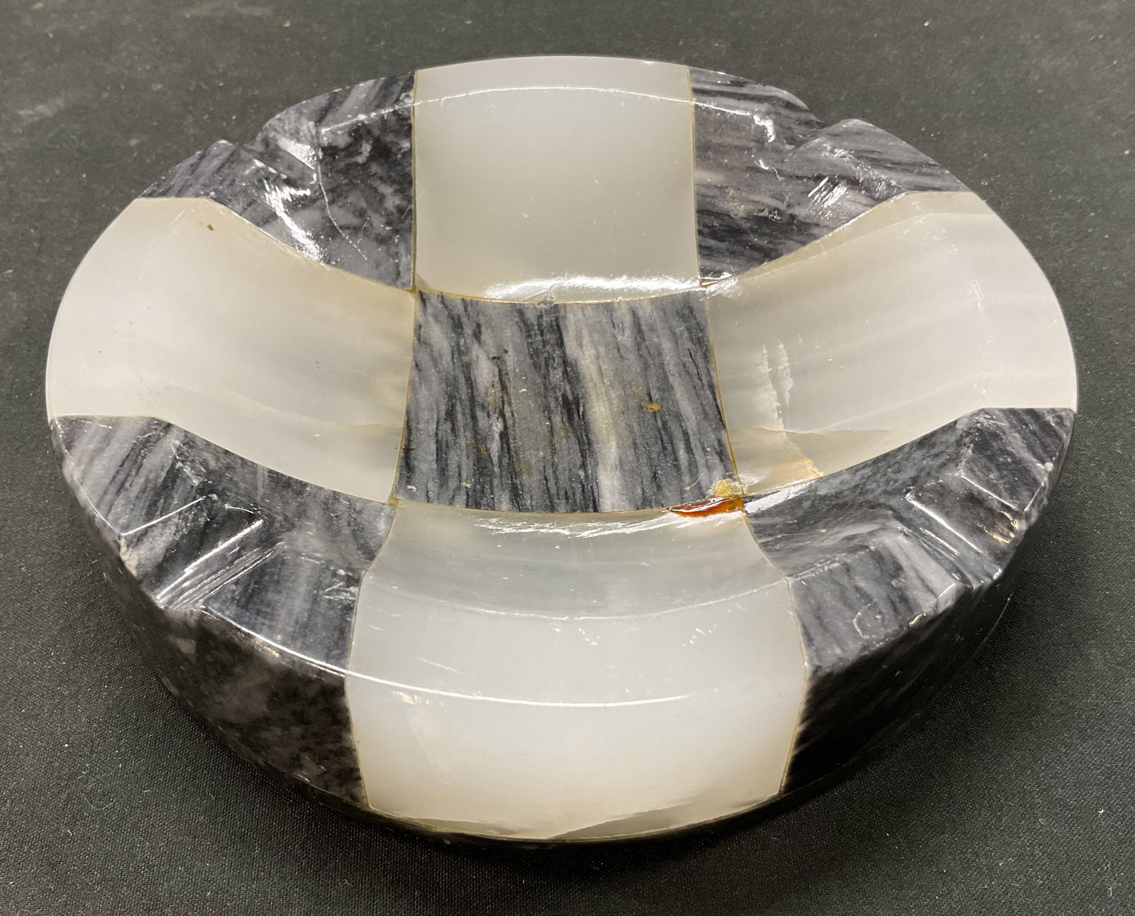 Vintage Black & White Checkered Stone Ashtray: Vintage black and white checkered stone ashtray. Checker pattern. Circular shape. Indentations. Heavy base. Measures ht approx 1.5 inches diam approx 6 inches. Scratching observed. Ashtray, vintage as