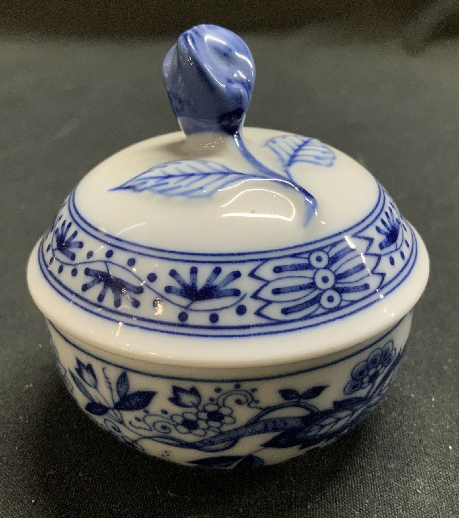 Vtg Hutschenreuther Porc Trinket Box GERMANY: Vintage hutschenreuther trinket box features blue floral accents & rosebud finial. Signed & marked on underside. Reads HUTSCHENREUTHER GERMANY. Surface wear consistent to age, use & exposure. Measurem