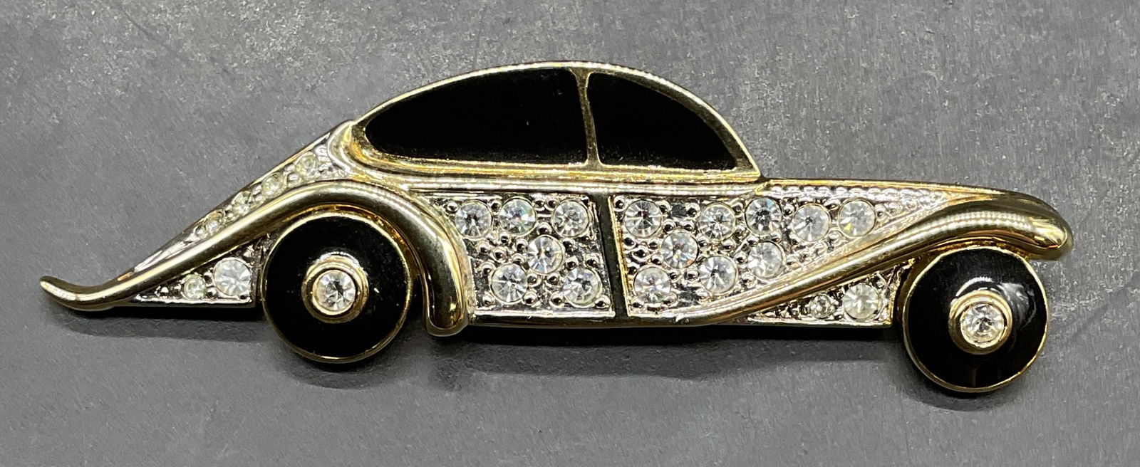 Vintage Carolee Gold Tn Crystal Automobile Brooch: Vintage signed Carolee gold tone enamel and crystal automobile brooch. Measures approx. 2.75 x .75 inches. Some scratching. Jewelry, estate jewelry, costume jewelry, cocktail jewelry, fashion jewelry,
