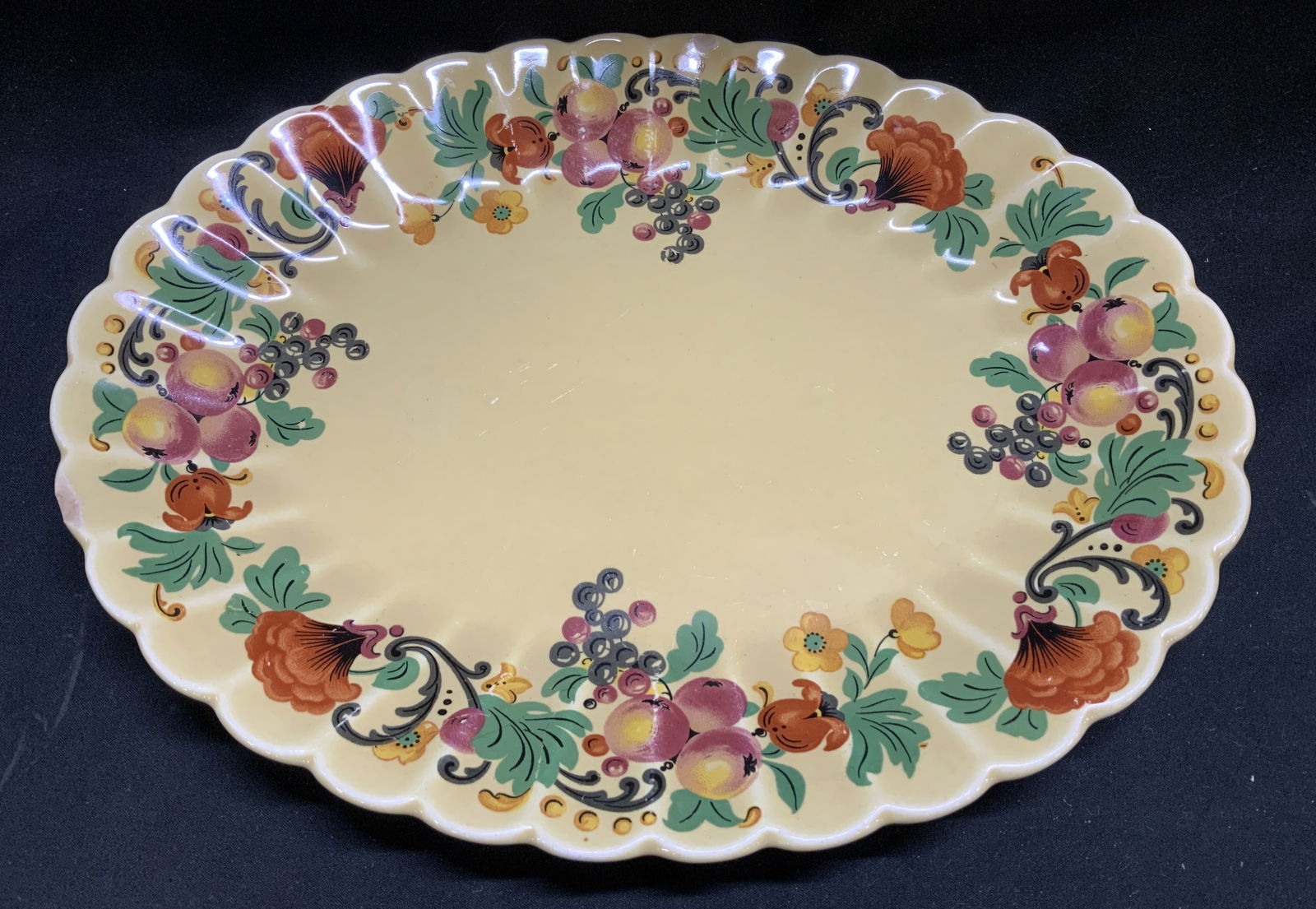 Vtg Trojan By Sebring Wild Fruit Platter USA: Vintage ceramic oval platter features a yellow glaze with fruit motifs. Signed & marked on underside. Reads, TROJAN BY SEBRING USA. WILD FRUIT DARK YELLOW GLAZE. Surface wear consistent to age, use &