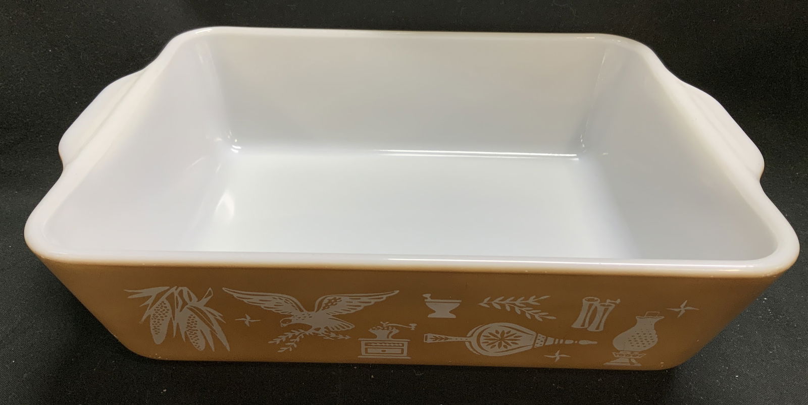 Vtg Pyrex Early American Casserole Dish USA: Vintage Pyrex Early American casserole dish features graphics of an eagle, corn & household items. Signed & marked on underside. Reads, PYREX USA MADE IN USA. Surface wear consistent to age, use & exp