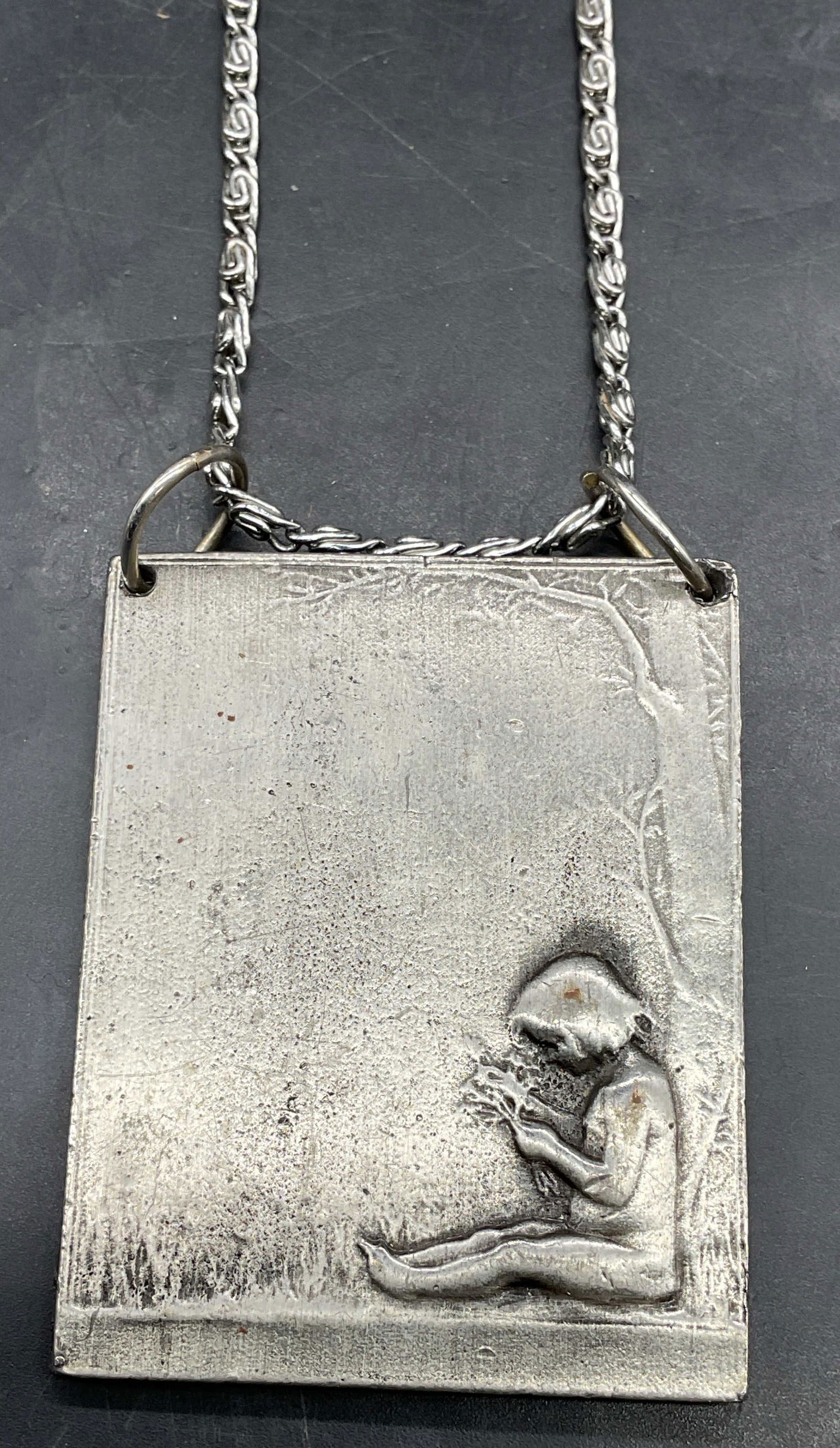Vtg Bergamot Brass Works Child Pendant USA: Vintage signed Bergamot Brass Works converted belt buckle pendant. Child sitting under tree. Measures approx. 2 3/8 x 1 7/8 inches. Made in USA. Includes a silver tone chain necklace, drop length appr