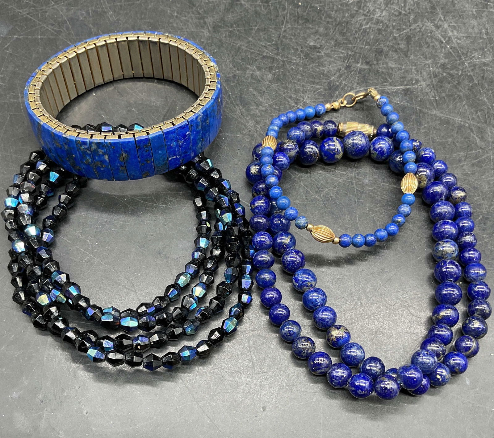 Lot 4 Lapis & Crystal Beaded Necklaces +: Lot of 4 jewelry pieces. Lapis beaded necklace, 2 lapis bracelets, and blue crystal beaded necklace. Longest necklace drop length approx 16 inches. Some scratching. Jewelry, estate jewelry, costume je