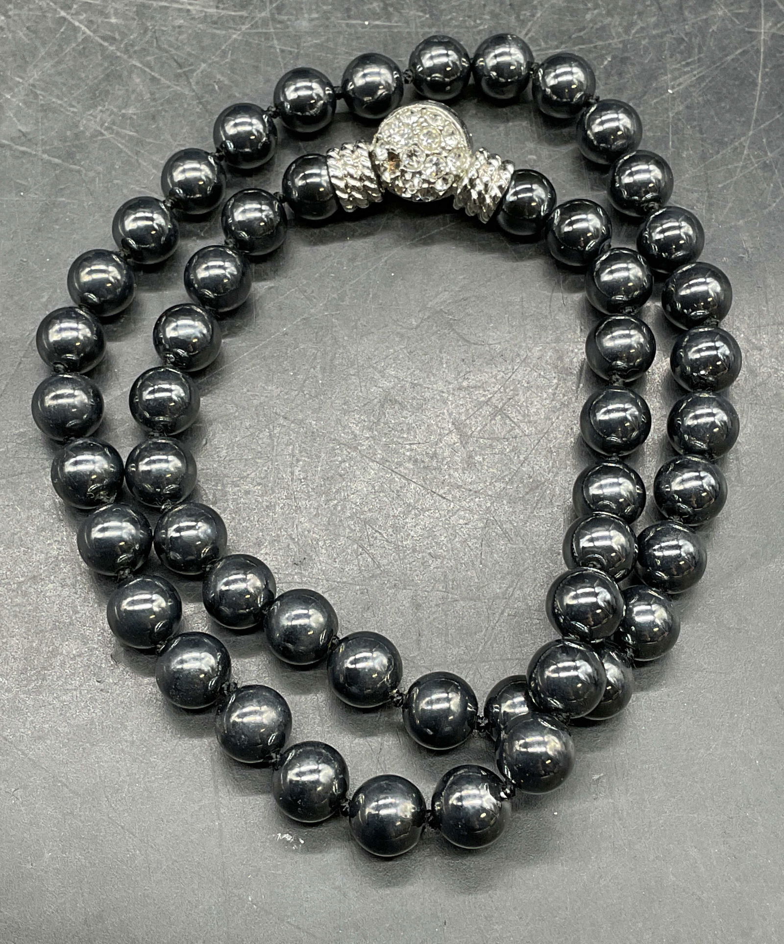 Vintage Silver Tone Faux Pearl Beaded Necklace: Vintage silver tone faux pearl beaded necklace with crystal clasp. Drop length approx 8 inches. One crystal needs replacement. Some scratching. Jewelry, estate jewelry, costume jewelry, cocktail