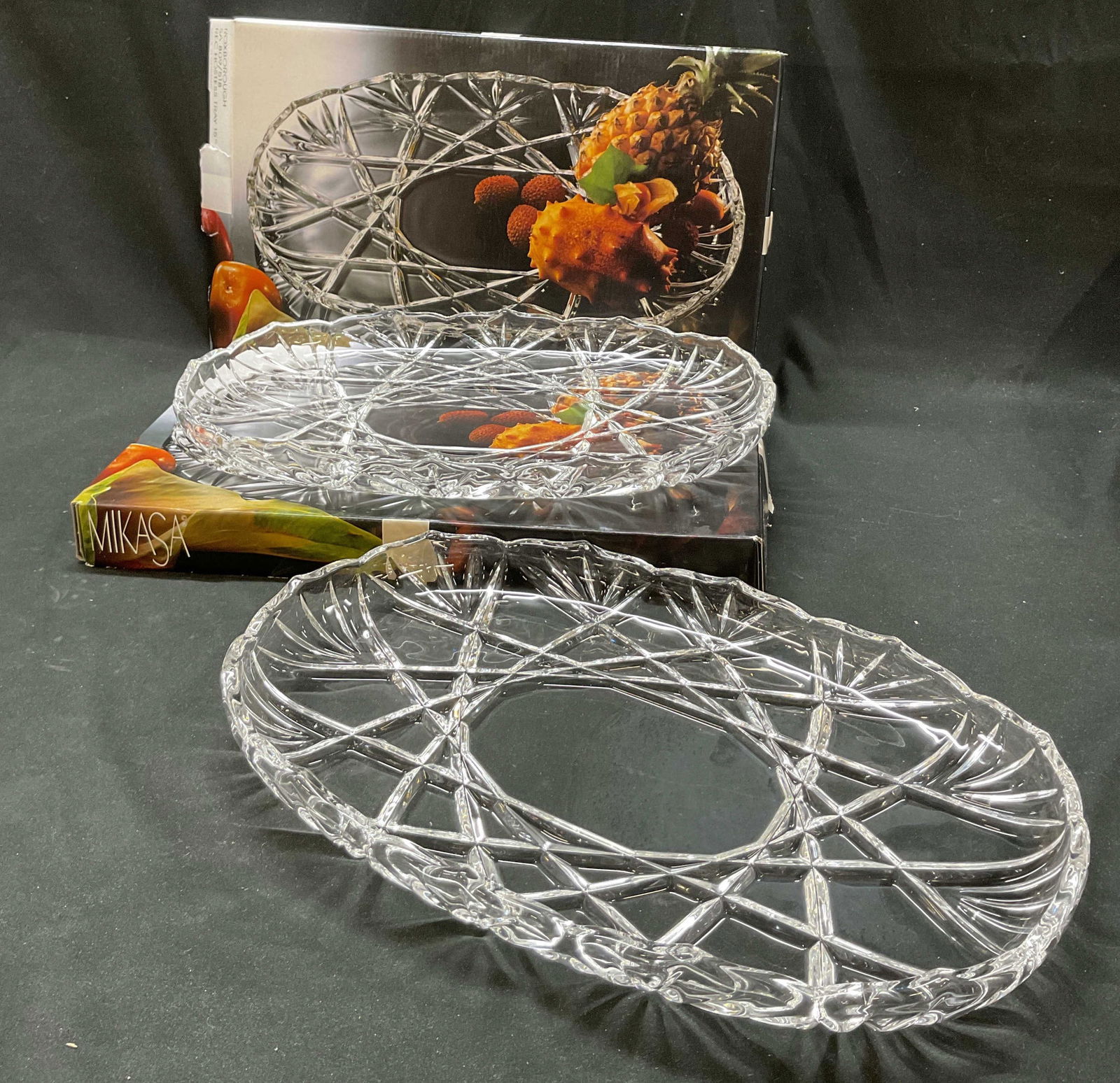Pair Mikasa Crystal Hostess Tray W Box Germany: Pair of Mikasa crystal Roxborough hostess tray. Made in Germany. Comes in original box. Scalloped edges. Cut geometric and fan patterns. Oval shape. Measures 15 inches in length according to box.