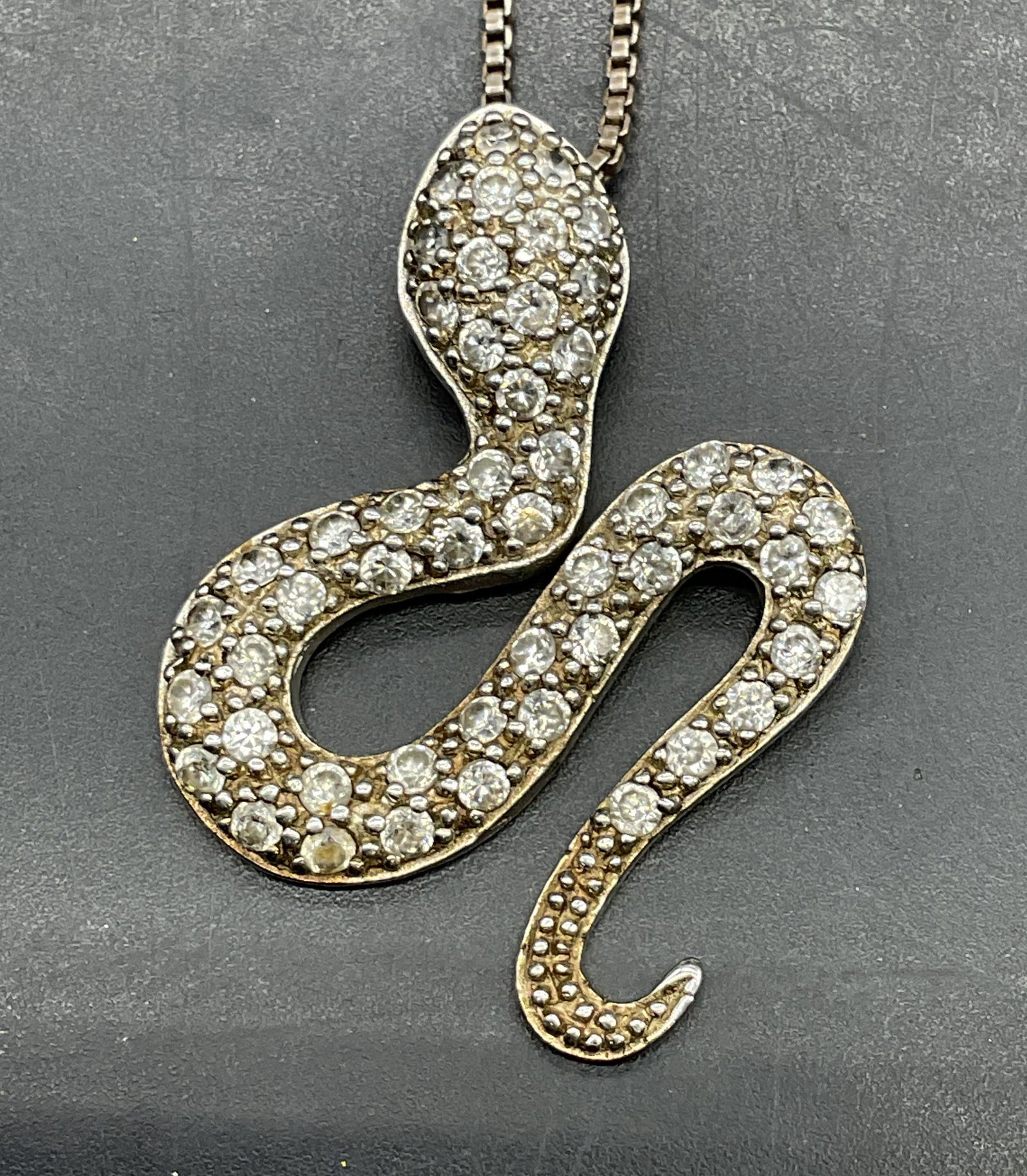 Sterling Silver Crystal Snake Pendant Necklace: Sterling silver necklace and snake pendant with crystal accents. Marked sterling. Drop length approx 7.5 inches. Total weight 8.7 grams. Some scratching. Jewelry, estate jewelry, fine jewelry, 