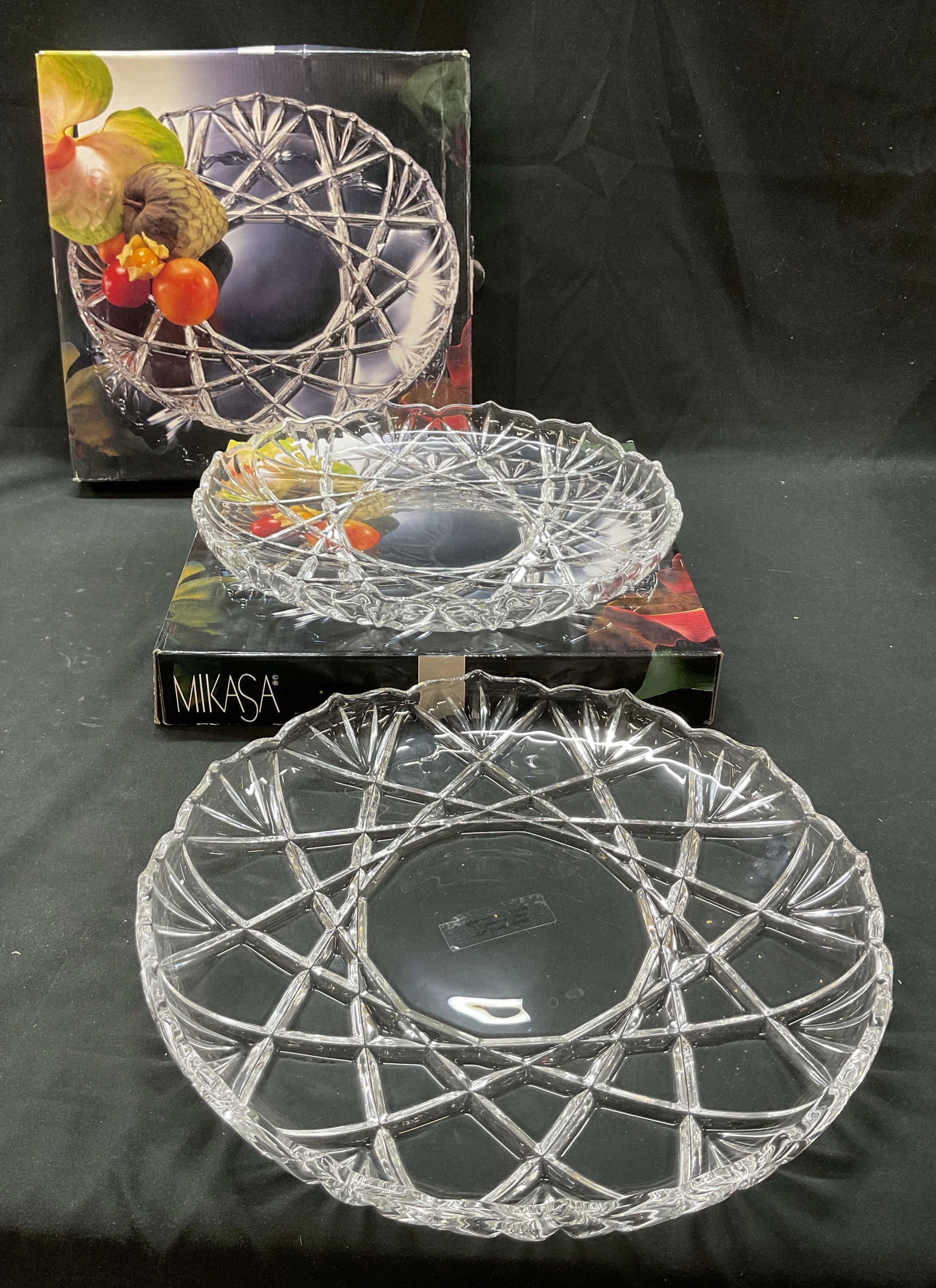 Pair Mikasa Crystal Serving Plate W Box Germany: Pair of Mikasa crystal Roxborough hostess serving plate. Made in Germany. Comes in original box. Scalloped edges. Cut geometric and fan patterns. Round shape. Measures 12.5 inches in diameter