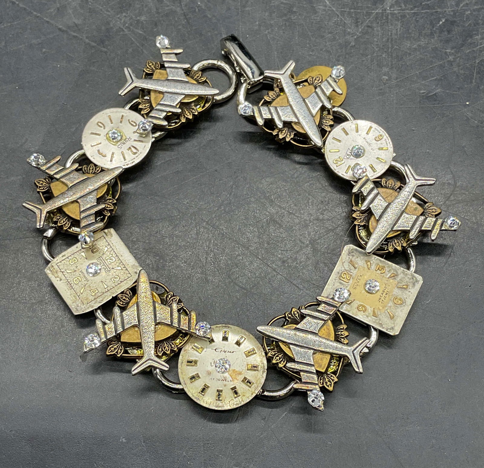 Vintage Lorraines Watch Airplane Bracelet: Vintage signed Lorraines Artistic Jewelry Design silver and gold tone watch dial and airplane motif bracelet. Measures approx 7 inches long. Some scratching. Jewelry, estate jewelry, costume