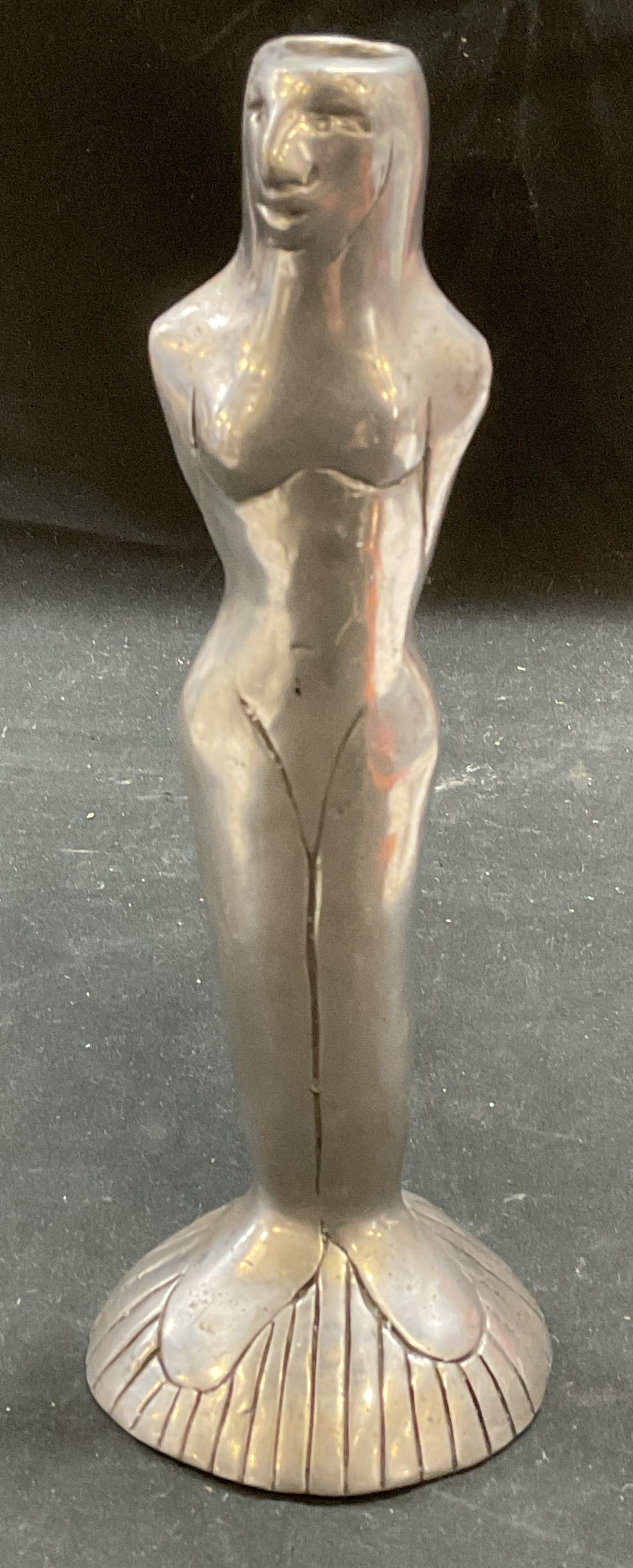 Carrol Boyes Woman Figural Candle Holder: Signed Carrol Boyes silver tone candle holder. Figure of a woman. Measures approx 3 x 7.75 inches. Some wear consistent with exposure. Carrol Boyes, figural candle holder, woman candle holder,