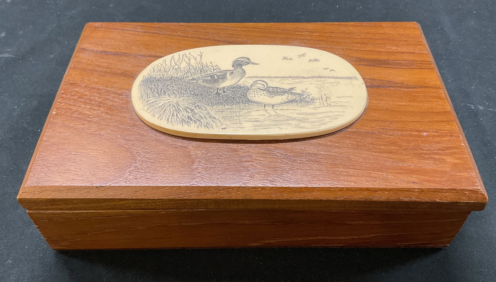 Vintage Wooden Duck Lidded Trinket Box: Vintage wooden duck lidded trinket box. Rectangular shape. Raised design of duck motifs by water and grass, featuring birds in the sky. Measures approx 4.5 x 7 x 2 inches. Surface wear consistent with