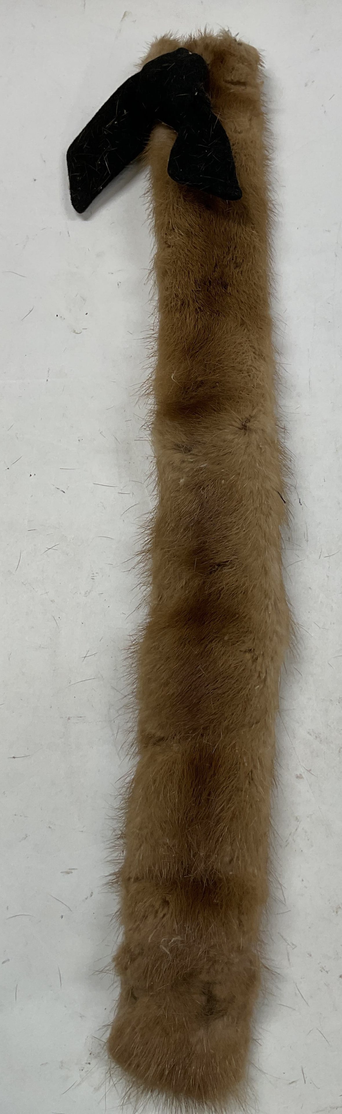 Vintage Brown Wearable Fur Collar: Vintage brown wearable fur collar. Fur material. Accented with black ribbon. Features hooks. Measures approx 3 x 23 inches. Wear consistent with exposure. Material is shedding. Property of opera