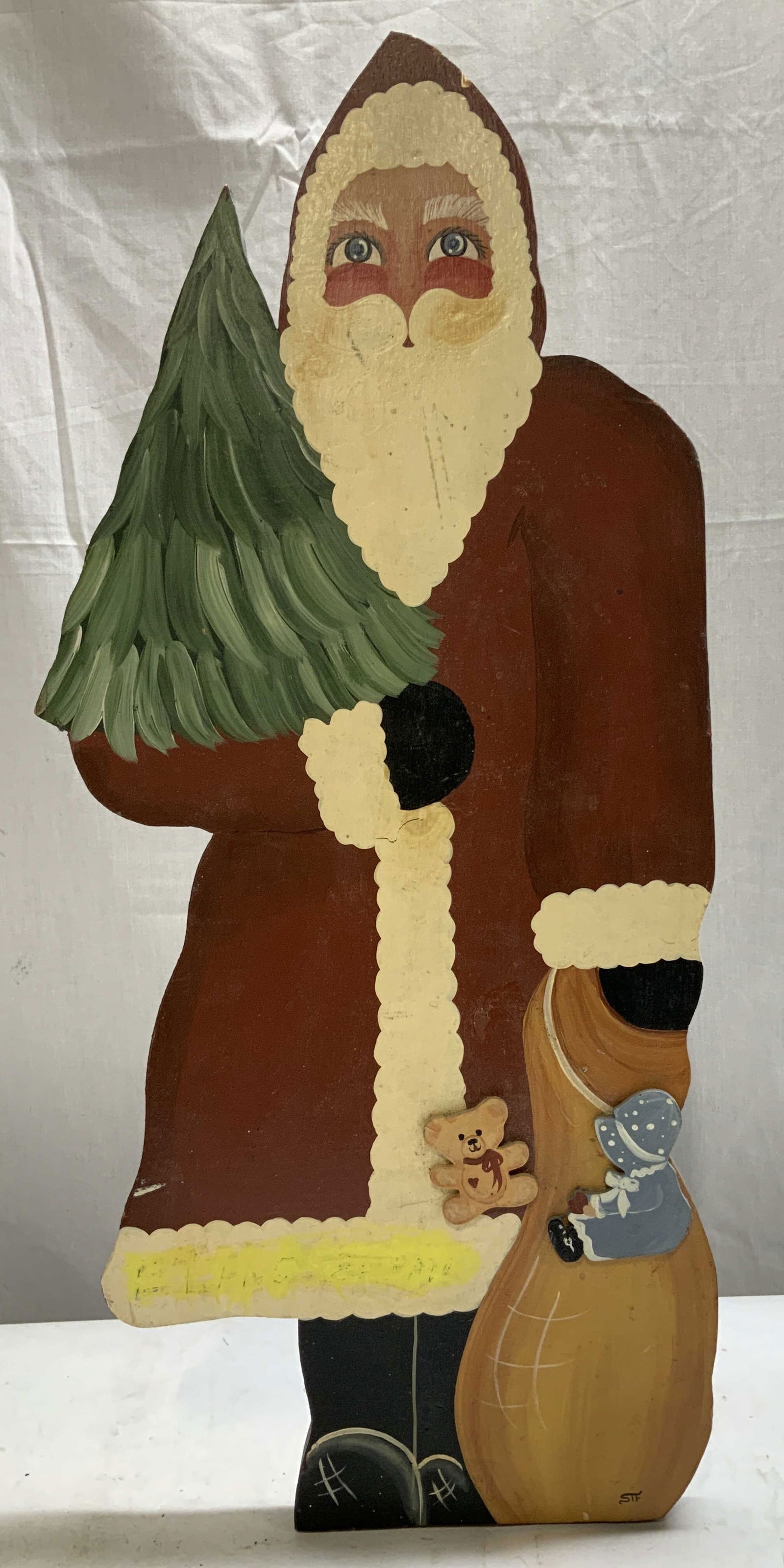 Simply Southerns Hand Painted Wooden Santa 23in: Hand painted wooden cutout depicting Santa Claus holding a Christmas tree. Support stand on backside. Signed & marked on underside. Reads, Handcrafted by Simply Southern. Athens, G.A. Surface