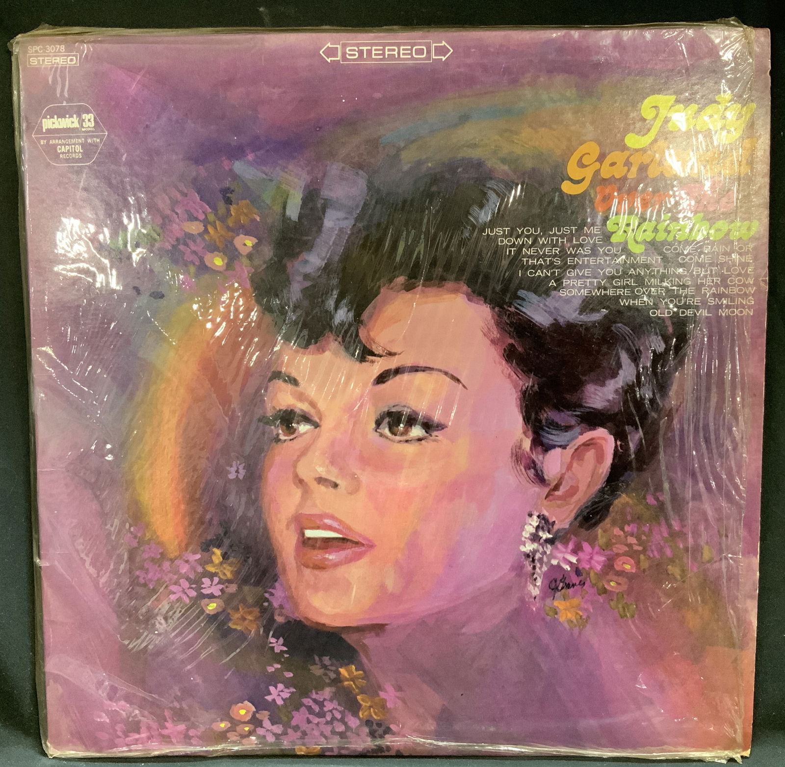 Vtg Judy Garland Over The Rainbow Vinyl Record: Vintage Judy Garland Over The Rainbow vinyl record album, released by Pickwick/33 Records. Features various hits. Has not been removed out of original plastic. Vinyl record has not been played, sold a