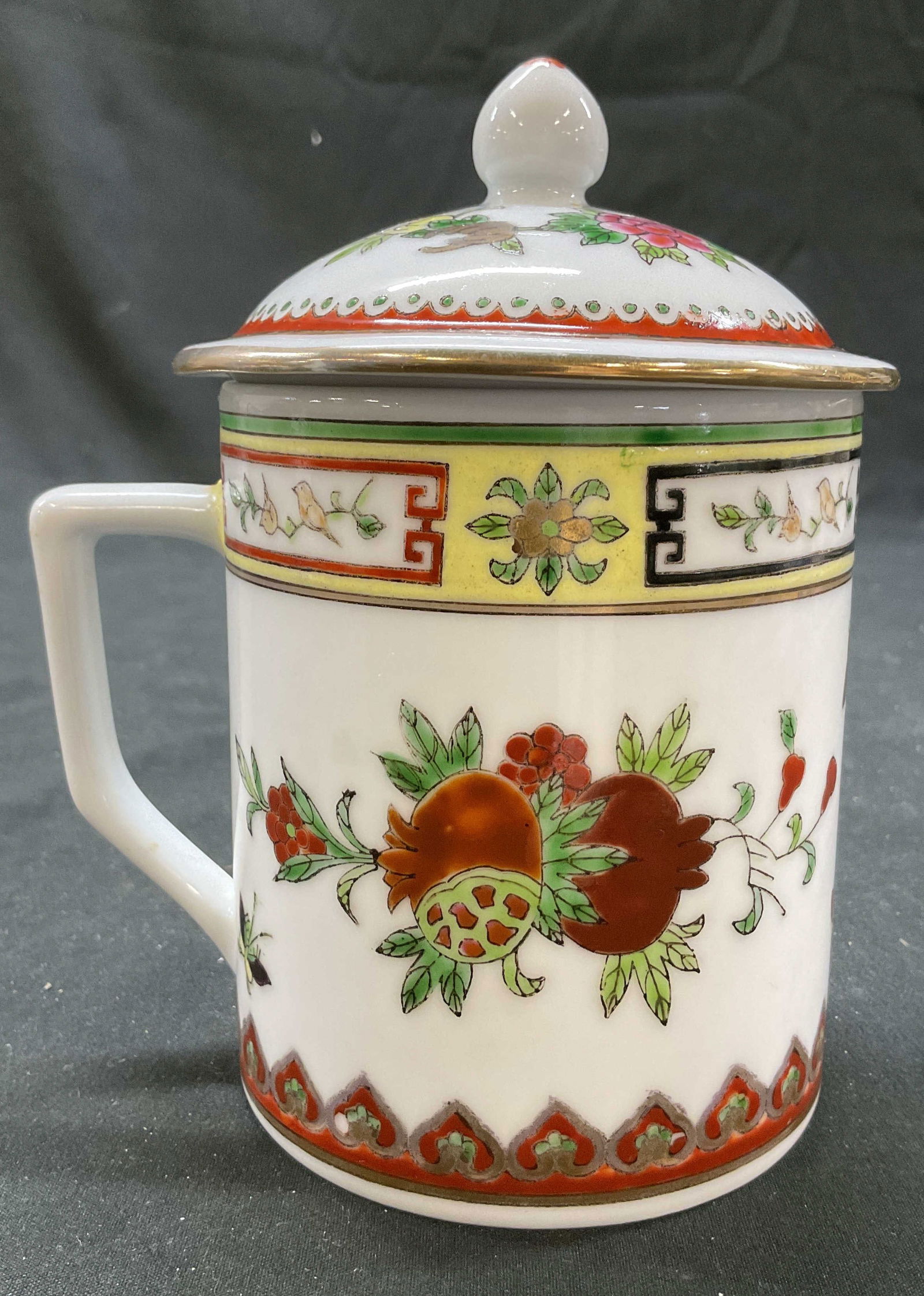 Vintage Jingdezhen Porcelain Lidded Teacup: Vintage Jingdezhen porcelain lidded teacup. Underside is marked with Chinese characters. Hand painted floral, butterfly, and scroll motifs. Colors consist of pink, red, green, yellow, and more. Lid ha