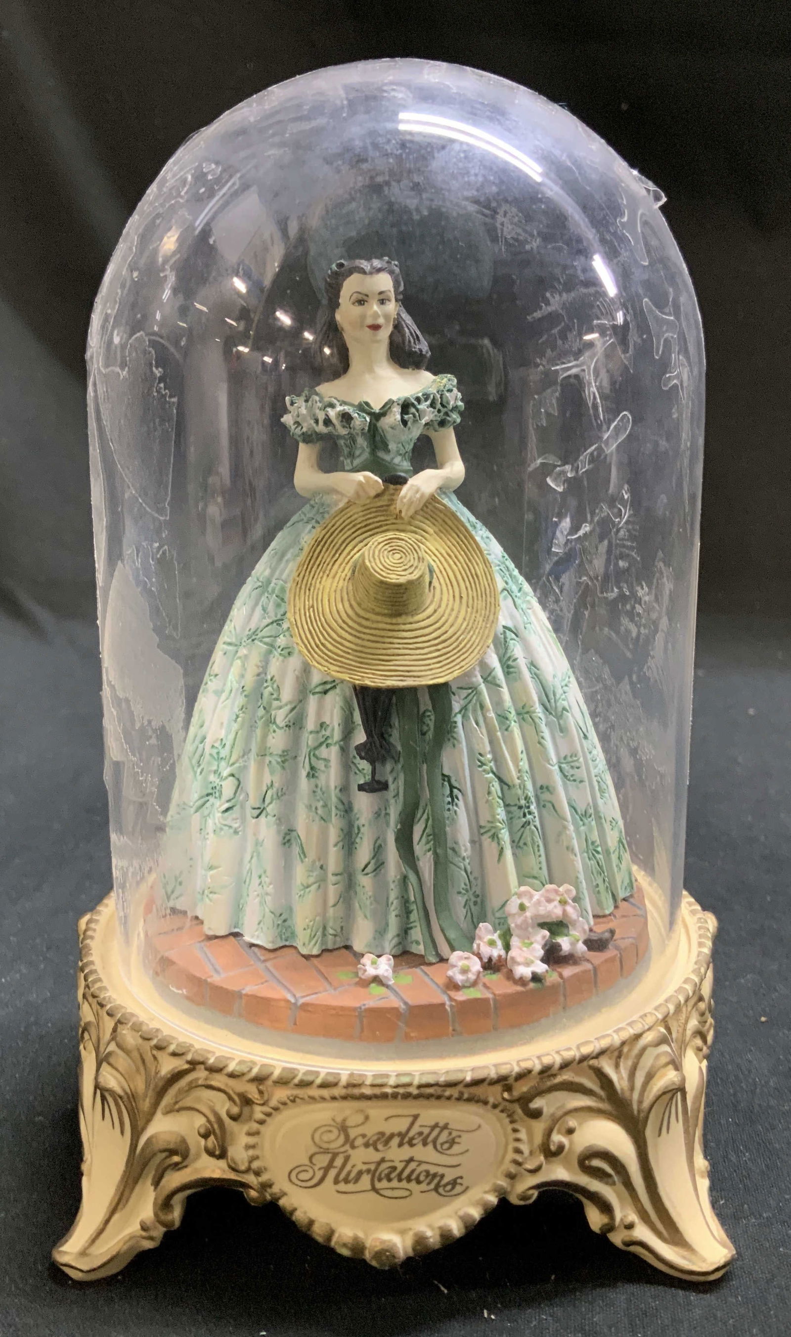 1993 Lmt Ed Scarletts Flirtations Gone W The Wind Fig: 1993 Limited Edition Scarletts Flirtations figurine depicts Scarlett in a floral dress & holding a hat. Comes in glass dome. Signed & marked on underside. Reads, 1993 TURNER Entertainment. SCARLETTS F