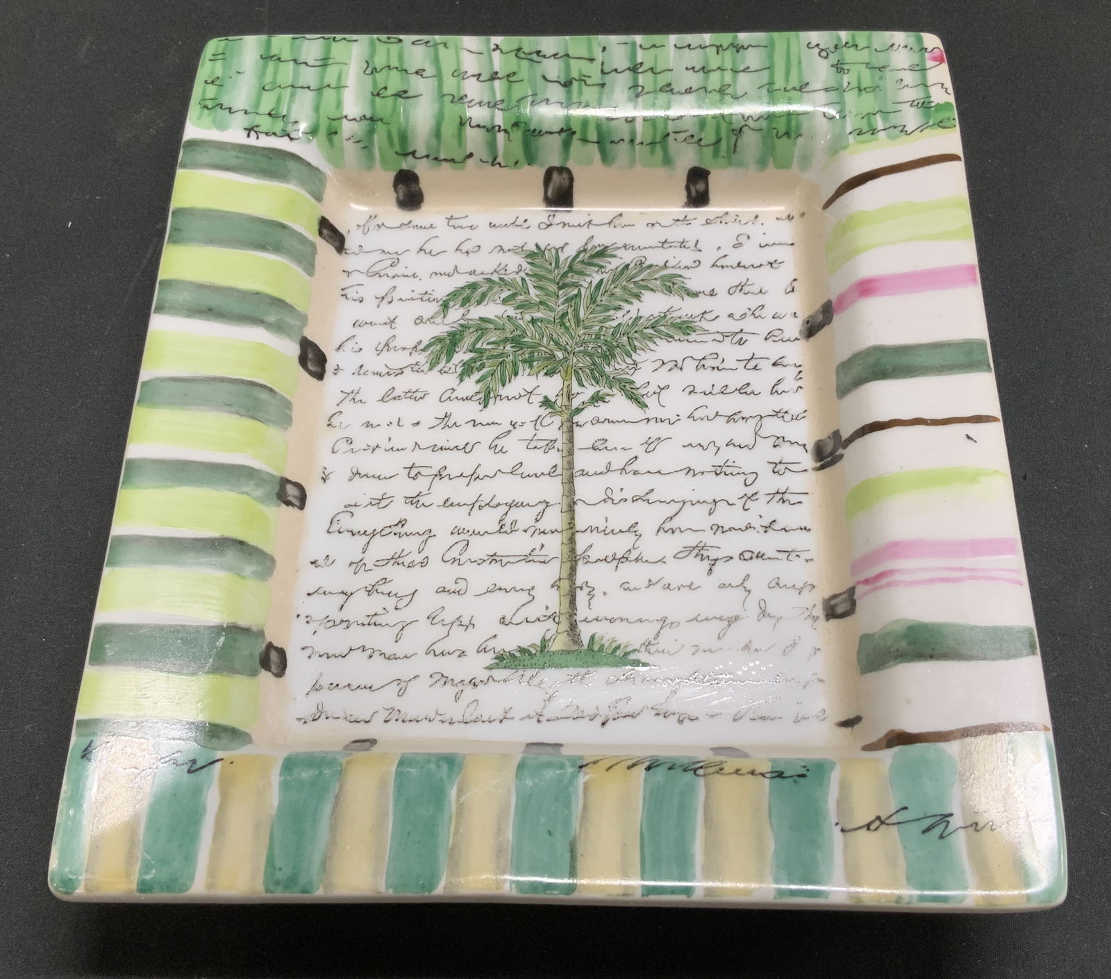John Derian Palm Tree Porc Deco Dish: John Derian Tozai Home decorative dish features an illustration of a palm tree in center & text. Striped rim. Porcelain material. Signed & marked on underside. Reads, JOHN DERIAN TOZAI HOME. Surface w