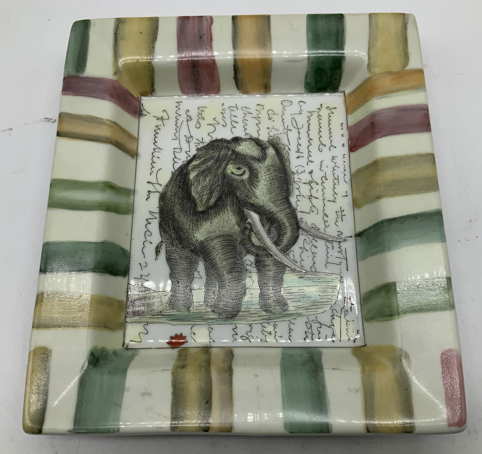 John Derian Elephant Deco Porc Dish: Tozai Home John Derian porcelain decorative dish features a hand painted elephant in center & striped rim. Signed & marked on underside. Reads, TOZAI HOME JOHN DERIAN. Surface wear consistent to age,