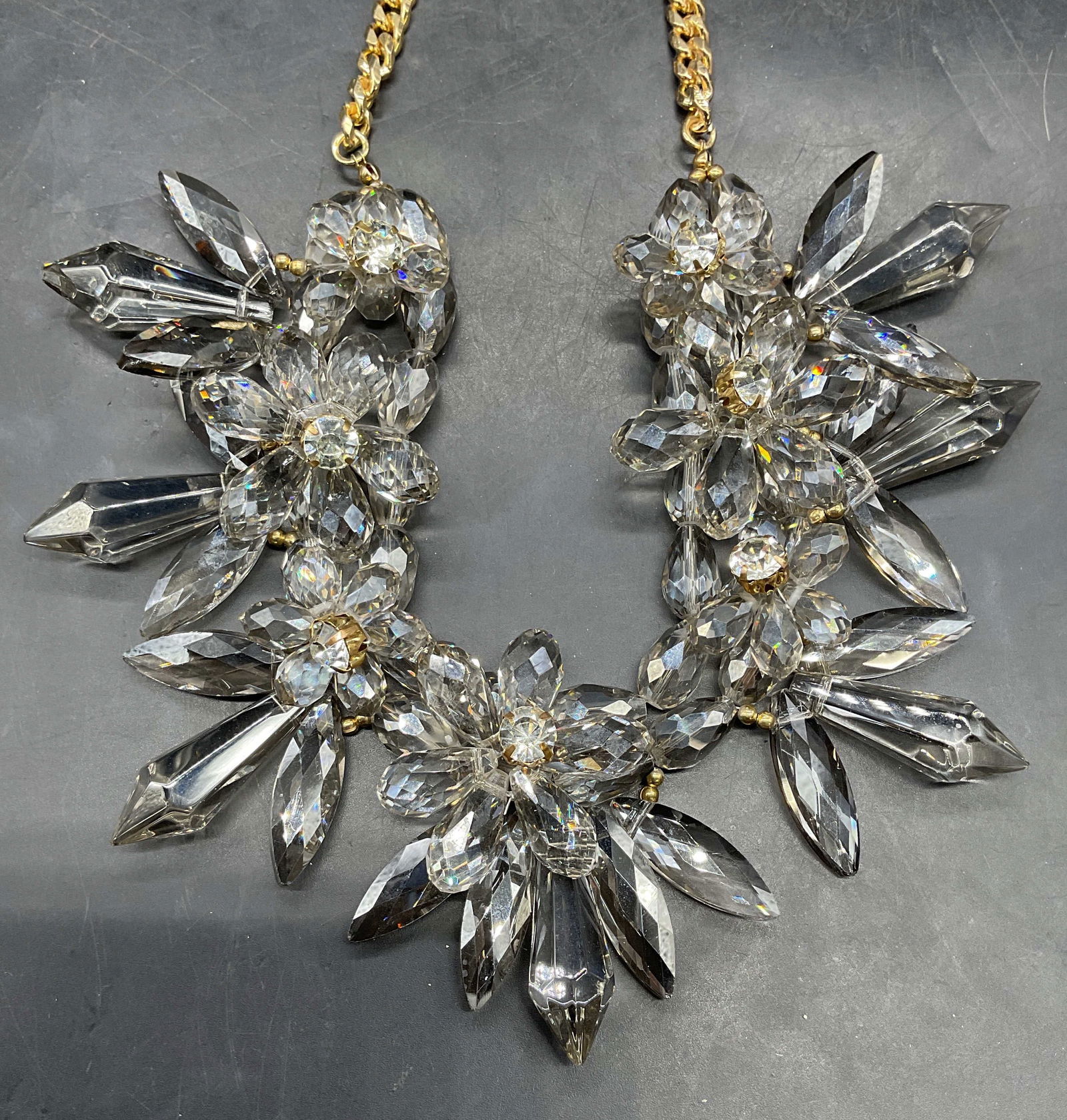 Natasha Gold Tone Crystal Flower Necklace NWT: Signed Natasha gold tone and smoky crystal flower necklace. New with tag. Drop length approx 10 inches. Some scratching. Jewelry, estate jewelry, costume jewelry, cocktail jewelry, fashion jewelry, ac