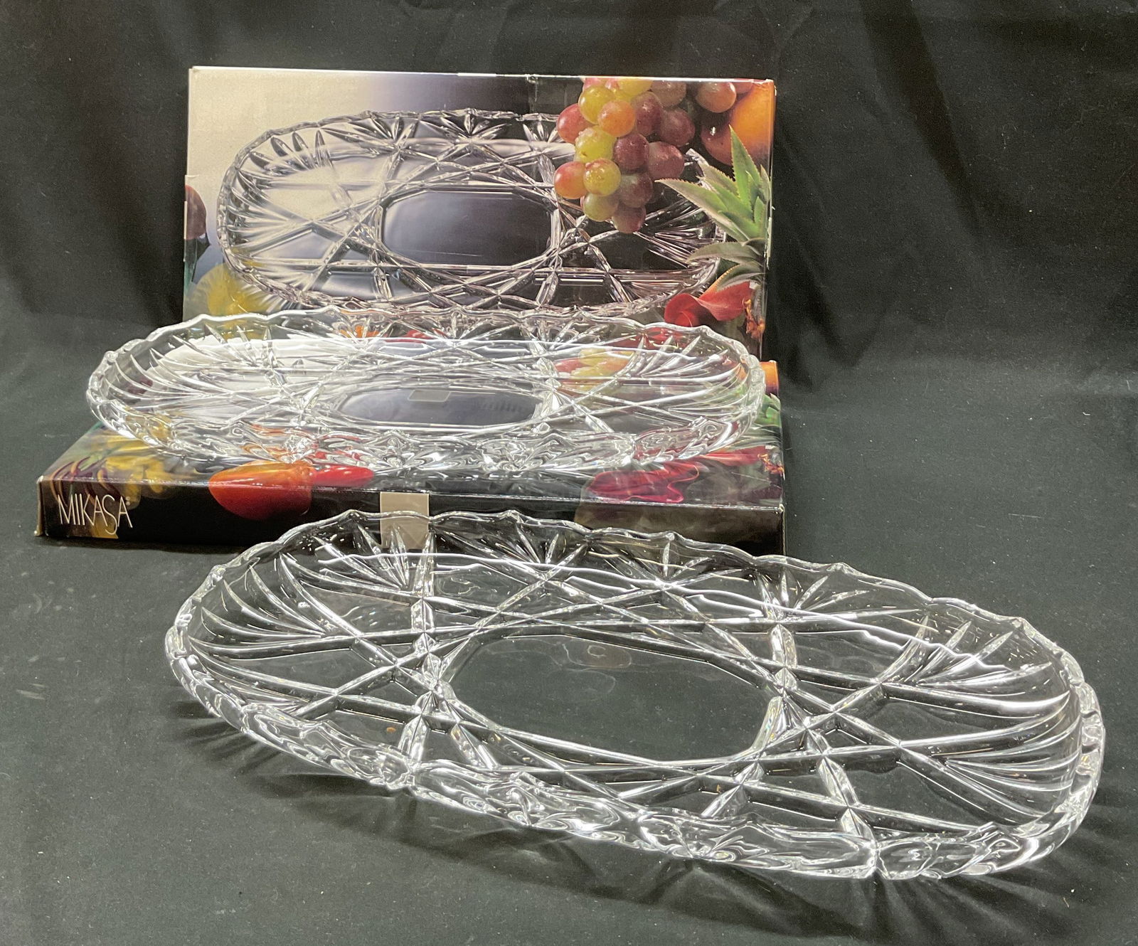 Pair Mikasa Crystal Canape Tray W Box Germany: Pair of Mikasa crystal Roxborough canape tray. Made in Germany. Comes in original box. Scalloped edges. Cut geometric and fan patterns. Oval shape. Measures 15 3/4 inches in length according to box. S