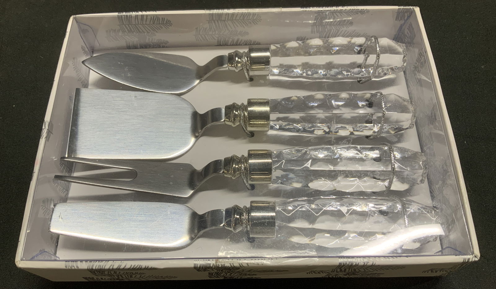 Wild Eye Designs Cheese Knife Set NIB: Wild Eye Designs cheese knife set, 4 pieces. Pieces are silver plated & feature a clear textured handle. Has not been inspected out of box. Sold as is. Surface wear consistent to age, use & exposure.