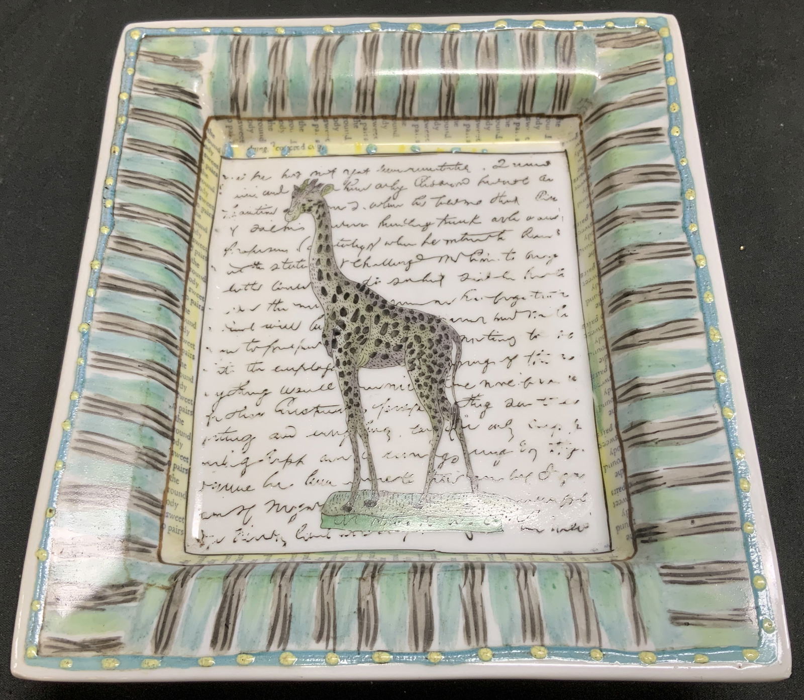 John Derian Giraffe Porcelain Deco Dish: John Derian porcelain decorative dish features an illustration of a giraffe & text in center. Striped rim. Signed & marked on underside. Reads, JOHN DERIAN. TOZAI HOME. Surface wear consistent to age,