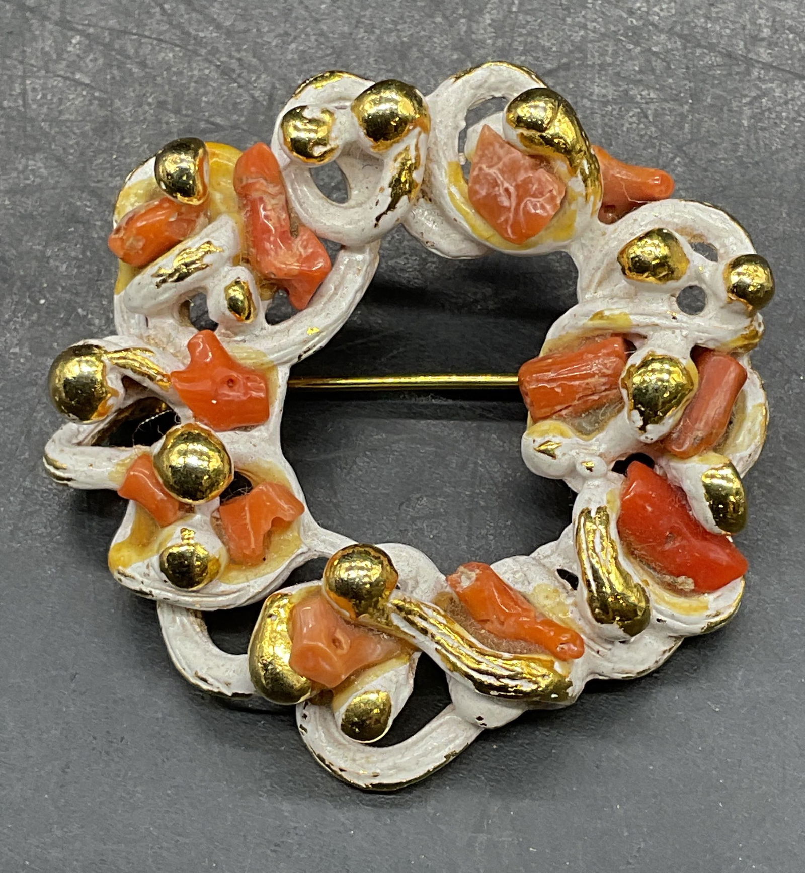 Vintage Zentall Gold Tn Enamel Coral Brooch: Vintage signed Zentall gold tone white enamel and coral branch wreath brooch. Measures approx. 1.5 inches wide. Some scratching. Jewelry, estate jewelry, costume jewelry, cocktail jewelry, fashion