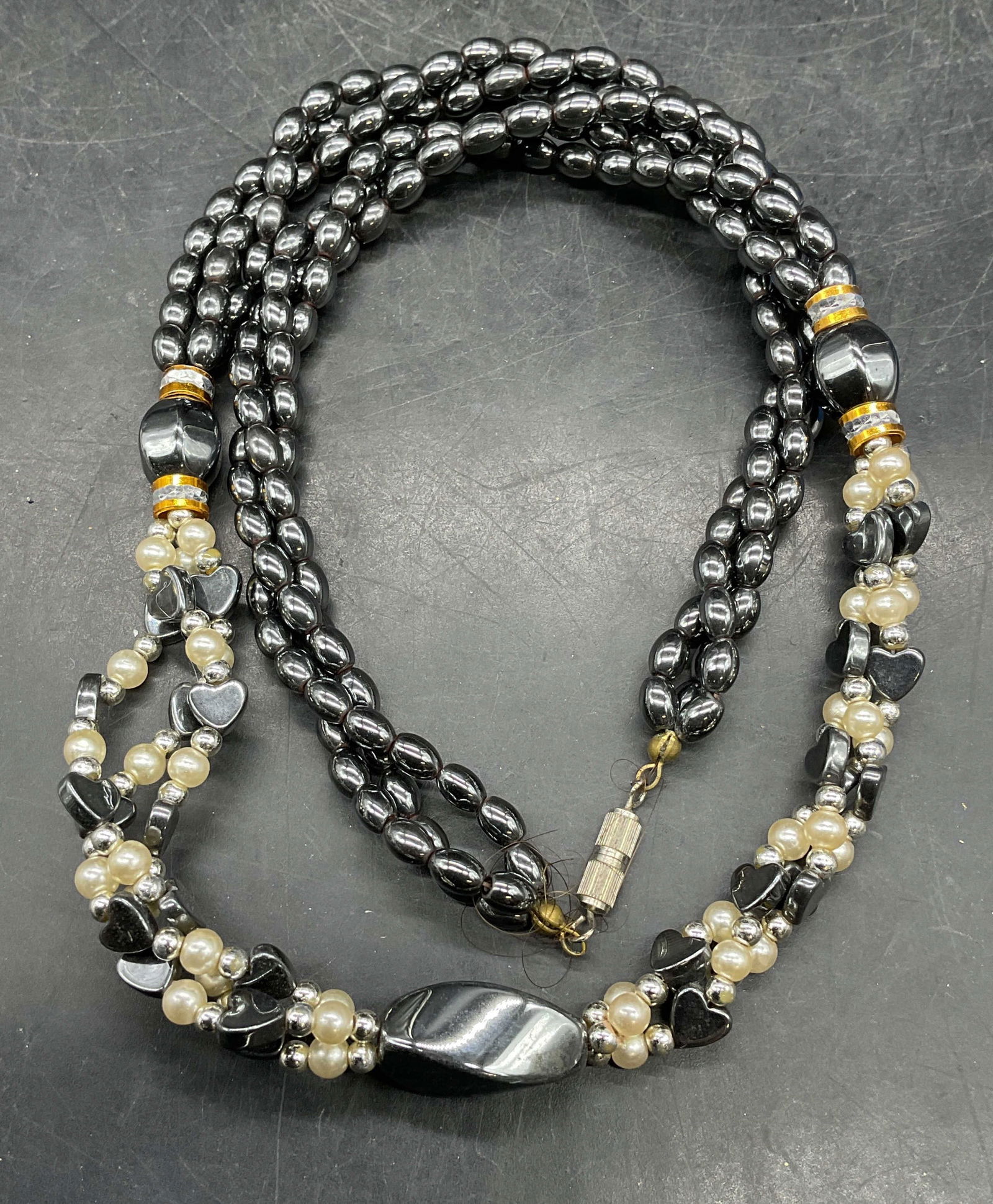 Vintage Faux Pearl Hematite Necklace: Vintage three strand twisted faux pearl and hematite beaded necklace. Drop length approx 10.5 inches. Some scratching. Jewelry, estate jewelry, costume jewelry, cocktail jewelry, fashion jewelry,