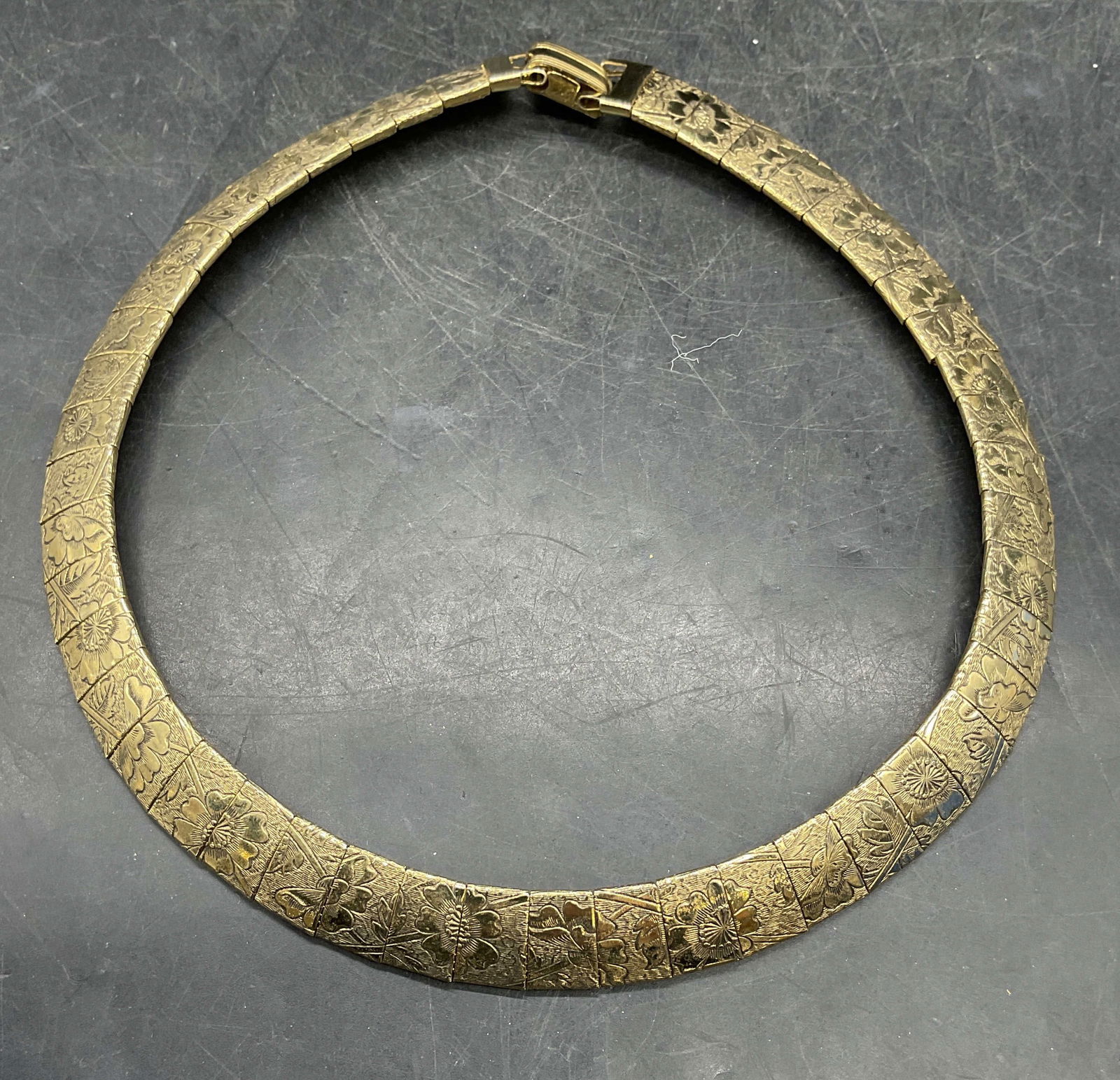 Vintage Gold Tone Floral Collar Choker Necklace: Vintage gold tone omega collar choker necklace with floral motif. Measures approx. 4.75 inches wide. Some scratching. Jewelry, estate jewelry, costume jewelry, cocktail jewelry, fashion jewelry,