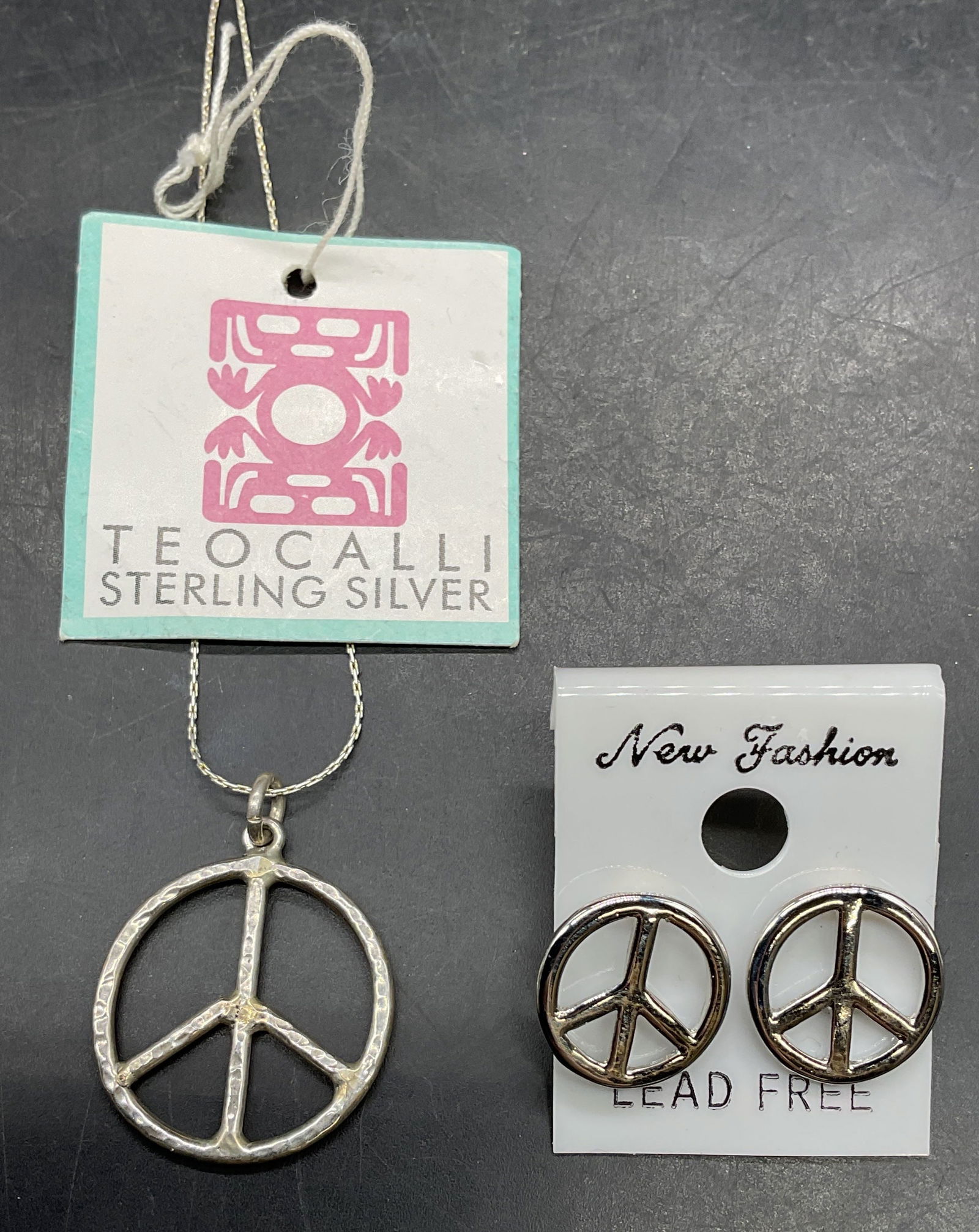 Lot 2 Teocalli Sterling Silver Peace Necklace NWT: Lot of 2 jewelry pieces. Signed Teocalli sterling silver necklace with peace sign pendant. New with tag. Made in Mexico. Marked sterling. Drop length approx 9.5 inches. Total weight 4.1 grams. Silver