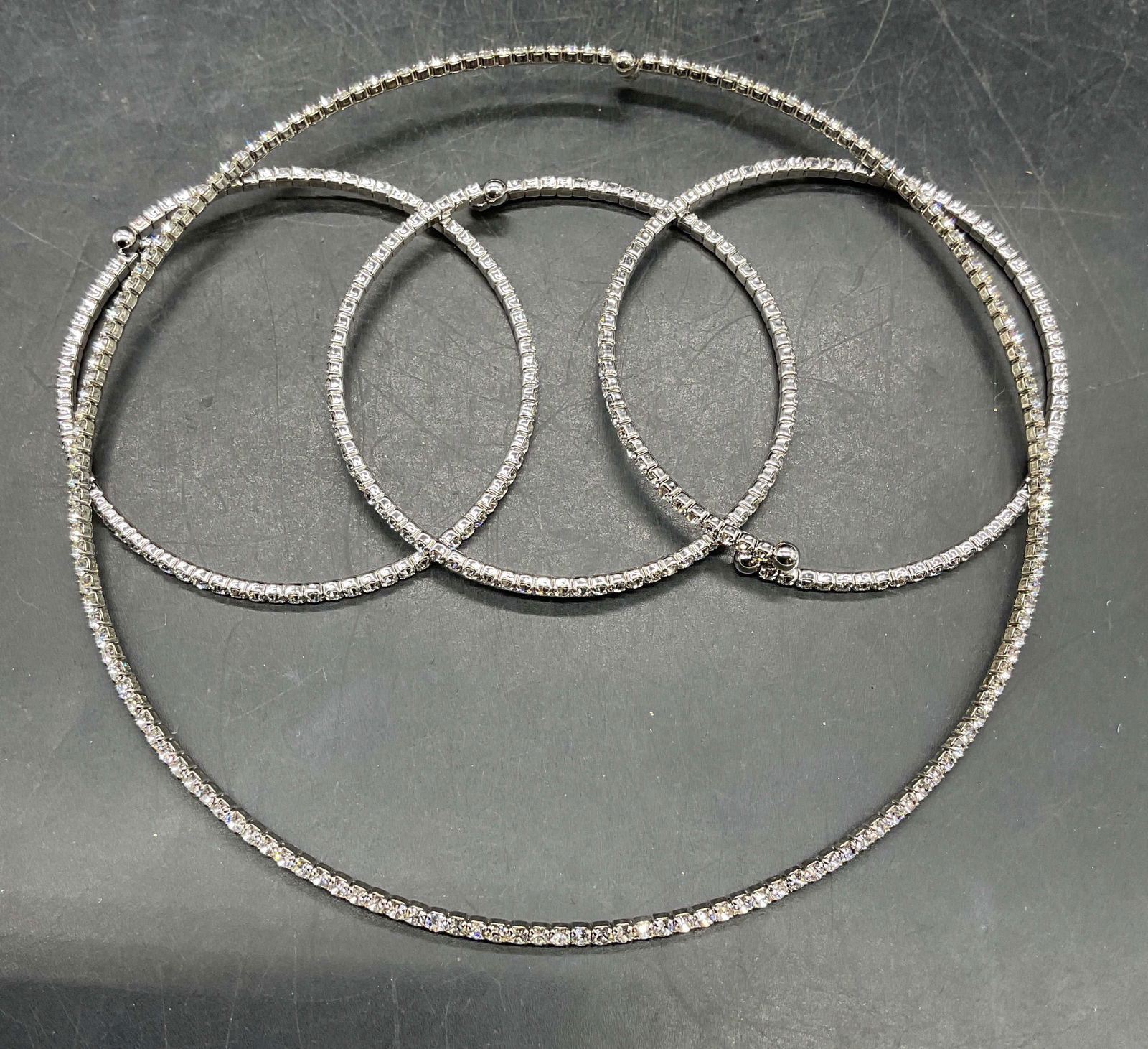 Lot 4 Silver Tone Crystal Necklace & Bracelets: Lot of 4 matching jewelry pieces. Silver tone crystal choker necklace and bracelets. Bracelets measures approx. 2.25 inches wide. Necklace measures approx. 4.25 inches wide. Some scratching. Jewelry,