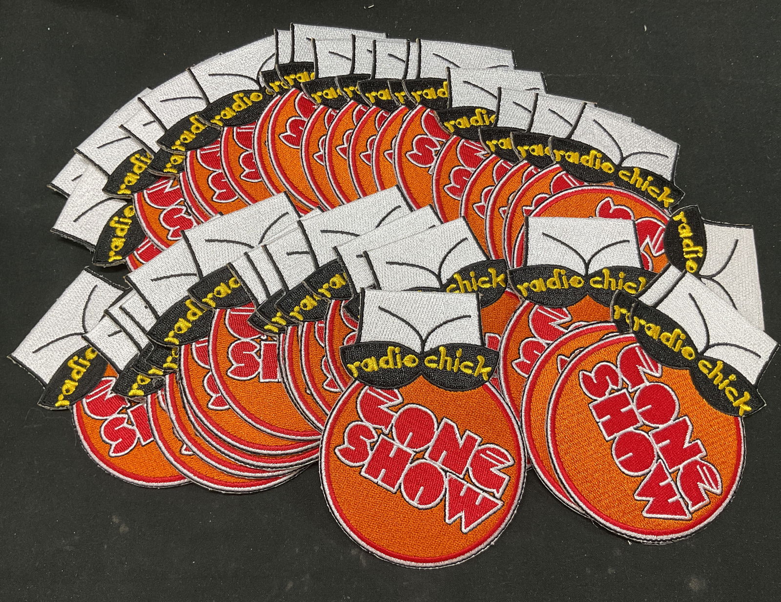 Lot 35 Gong Show Embroidered Promo Patches: Lot of 35 Gong Show embroidered promotional patches. Reads Radio Chick Gong Show in varying colors. Gong Show was an amateur talent contest show airing in 1976. Circle with a cartoon depiction of