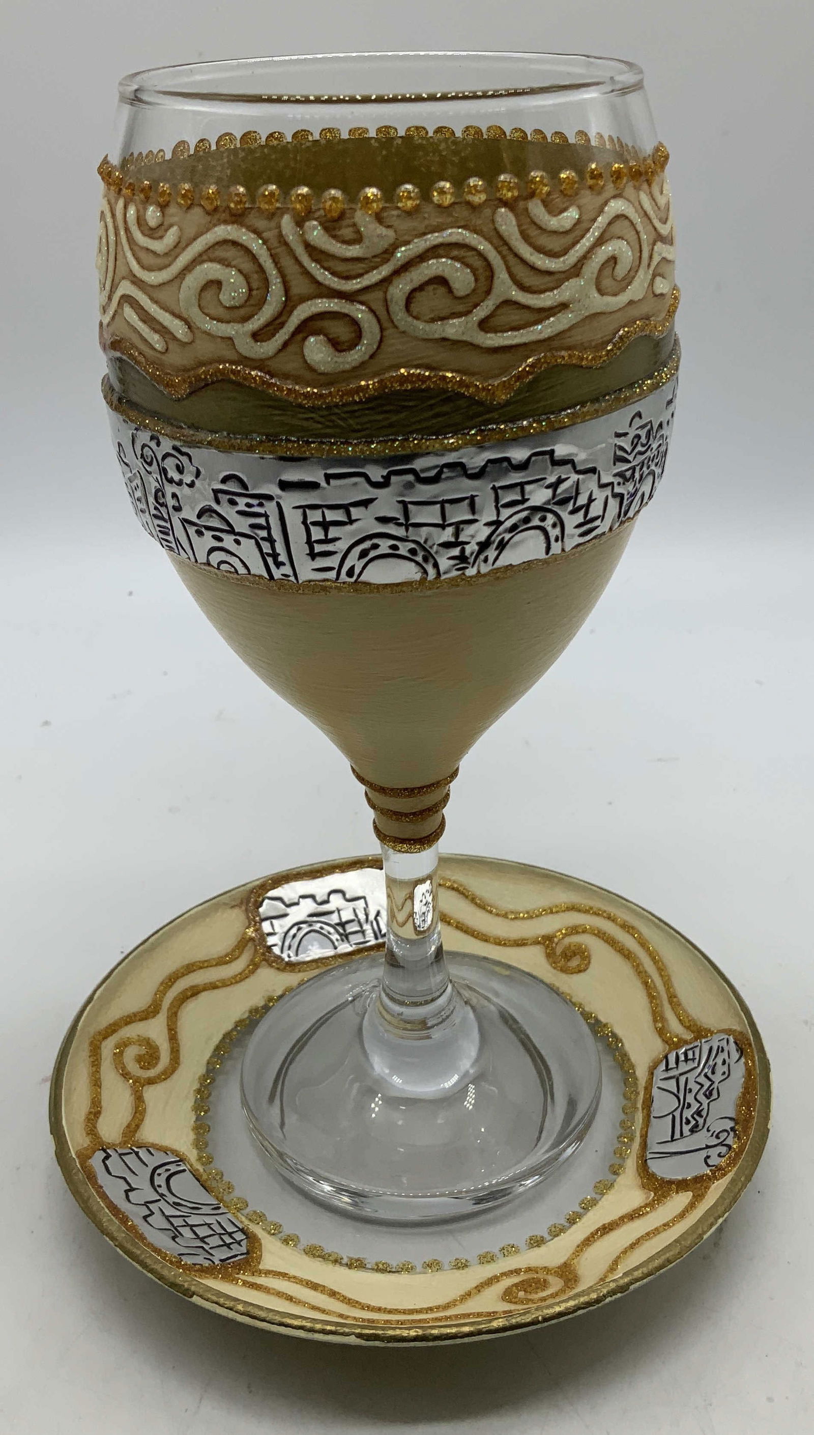 Hand Decorated Passover Eljiahs Cup: Elijahs cup comes with matching saucer. Features intricate designs with silver toned & gold accents. Illustrations of buildings & swirl motifs. Glass material. Surface wear consistent to age, use & ex