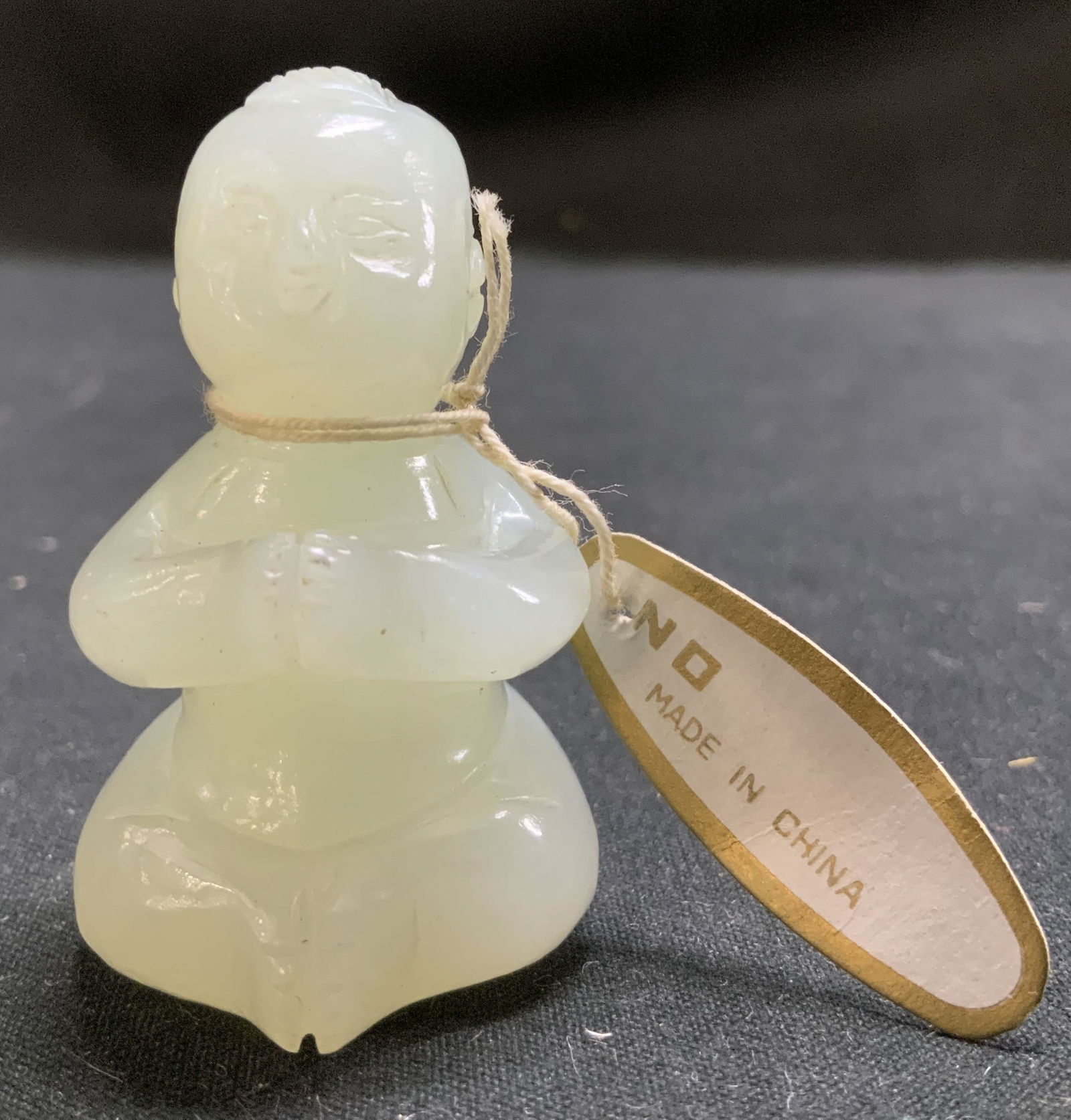 Vtg Hand Carved Stone Sitting Child Fig: Vintage hand carved stone figurine depicts a child in a seated position. Surface wear consistent to age, use & exposure. Measurements: length 1.3in x width 1.3in x height 2in. Hand carved stone sittin