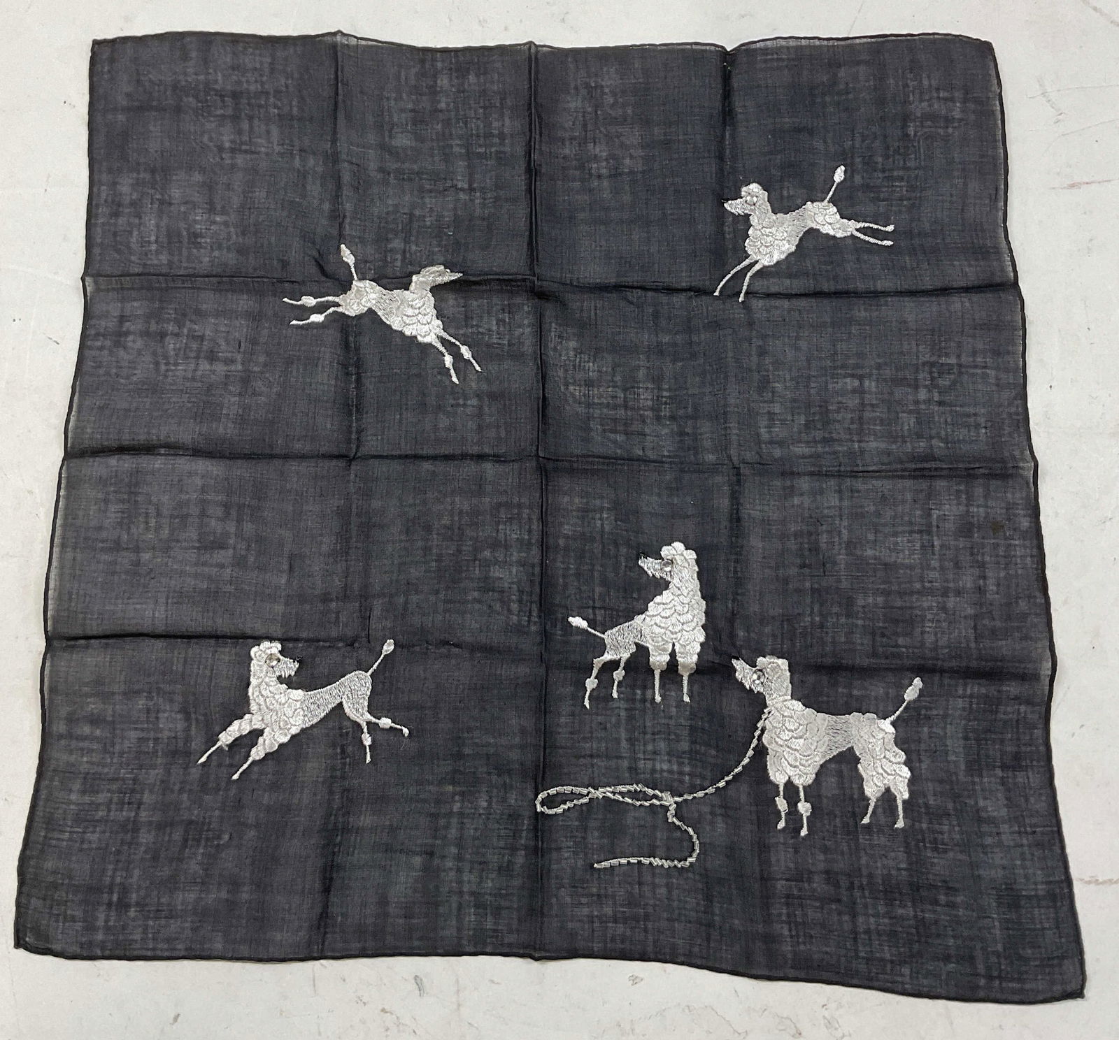 Vintage Embroidered Poodle Handkerchief: Vintage embroidered poodle handkerchief. Cotton feel. Black sheer background. Embroidered white poodle motifs with embellishments. Measures approx 15 x 15 inches. Wear consistent with exposure. Proper
