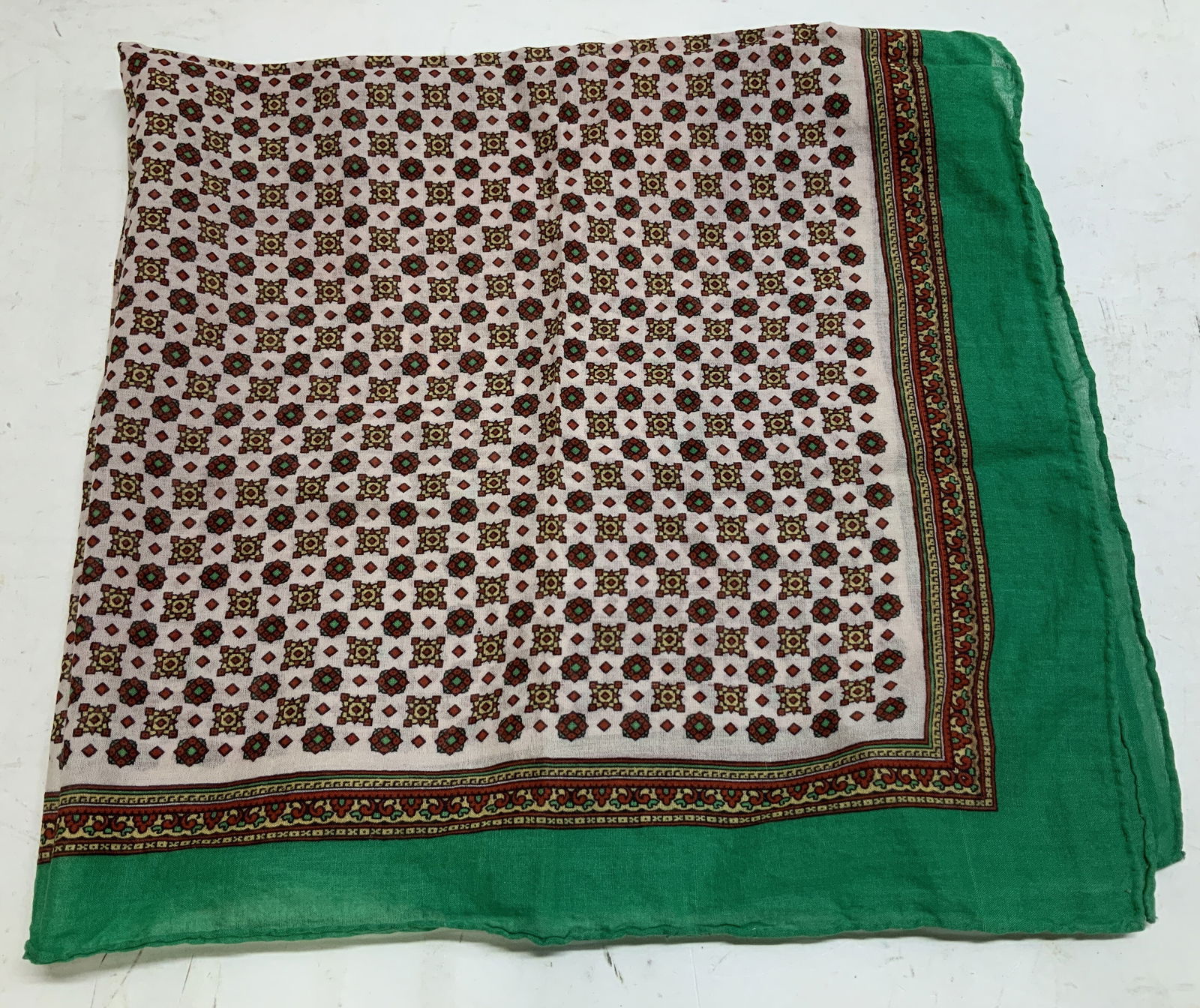 Vtg Green & Red Geometric Square Scarf: Vintage square scarf features a repeating pattern of geometric motifs in center. Green border. Feels like synthetic material. Property of opera singers estate from the renowned & opulent